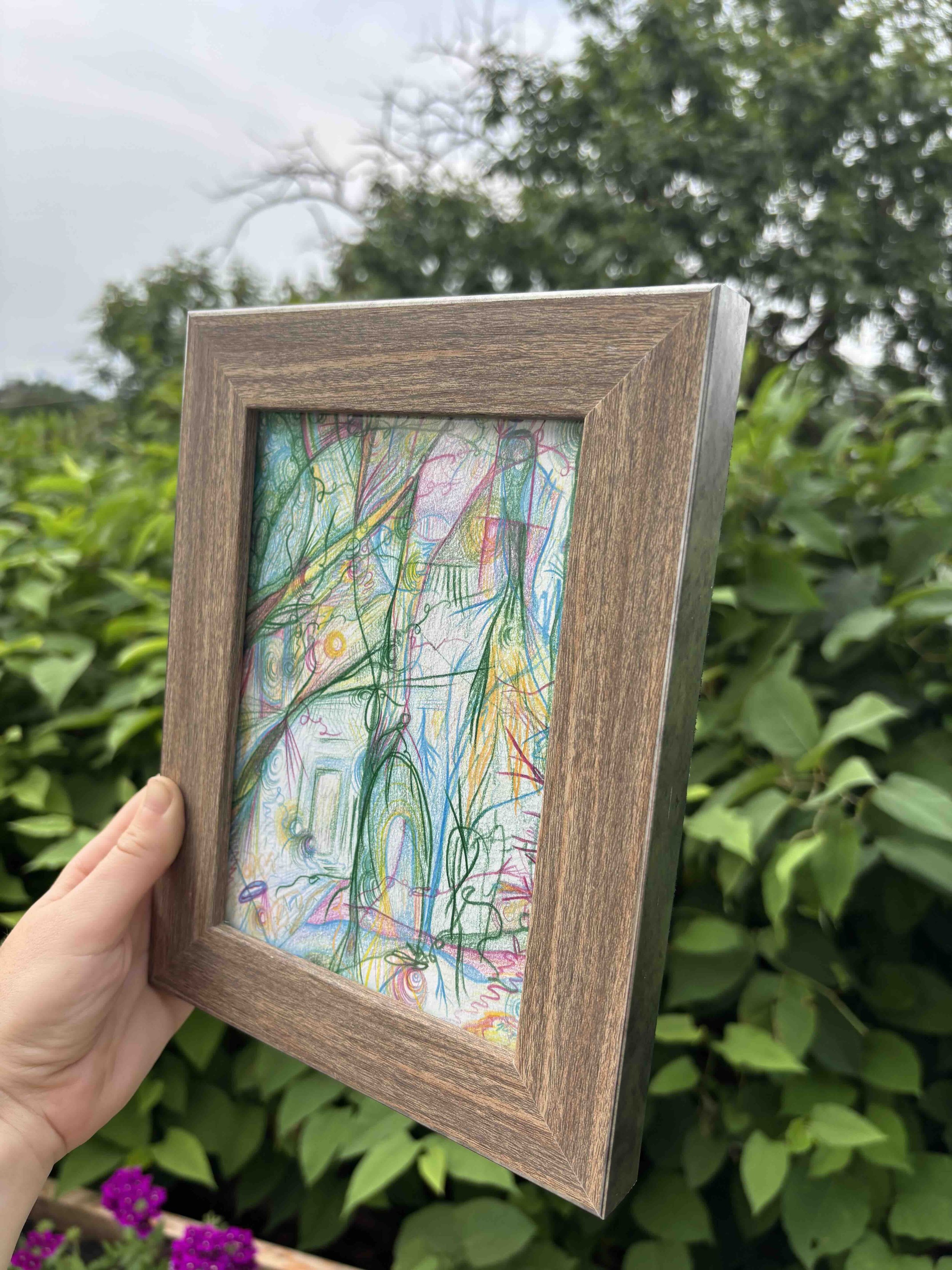 side-view-of-art-in-wood-frame-shown-in-garden.jpg