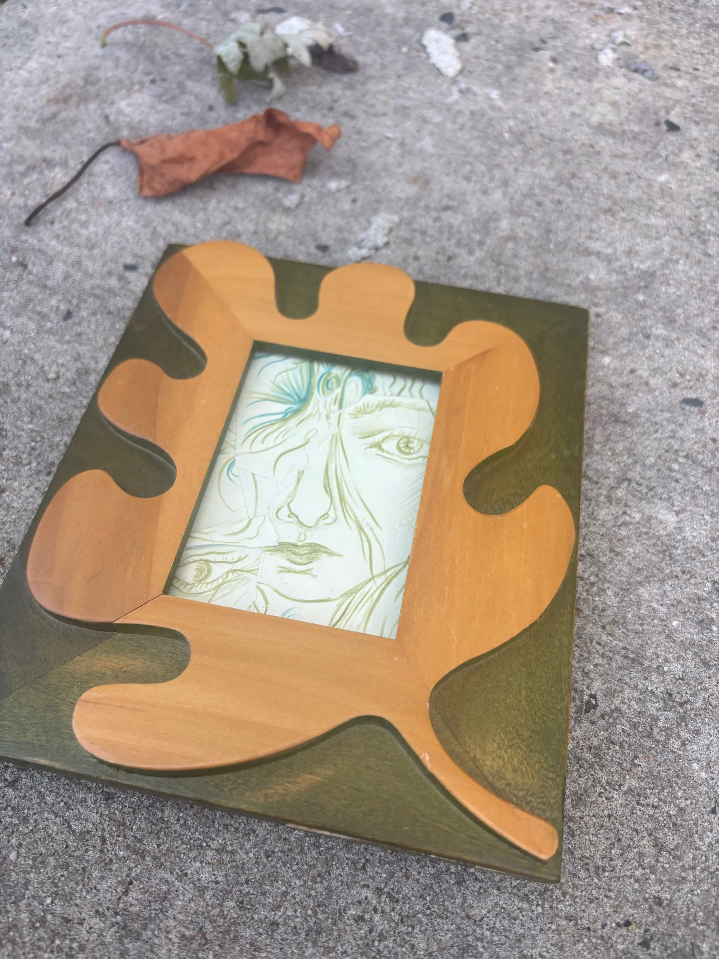 framed artwork by Nicole Javorsky about multiplicity of selves displayed near dying leaves.jpeg