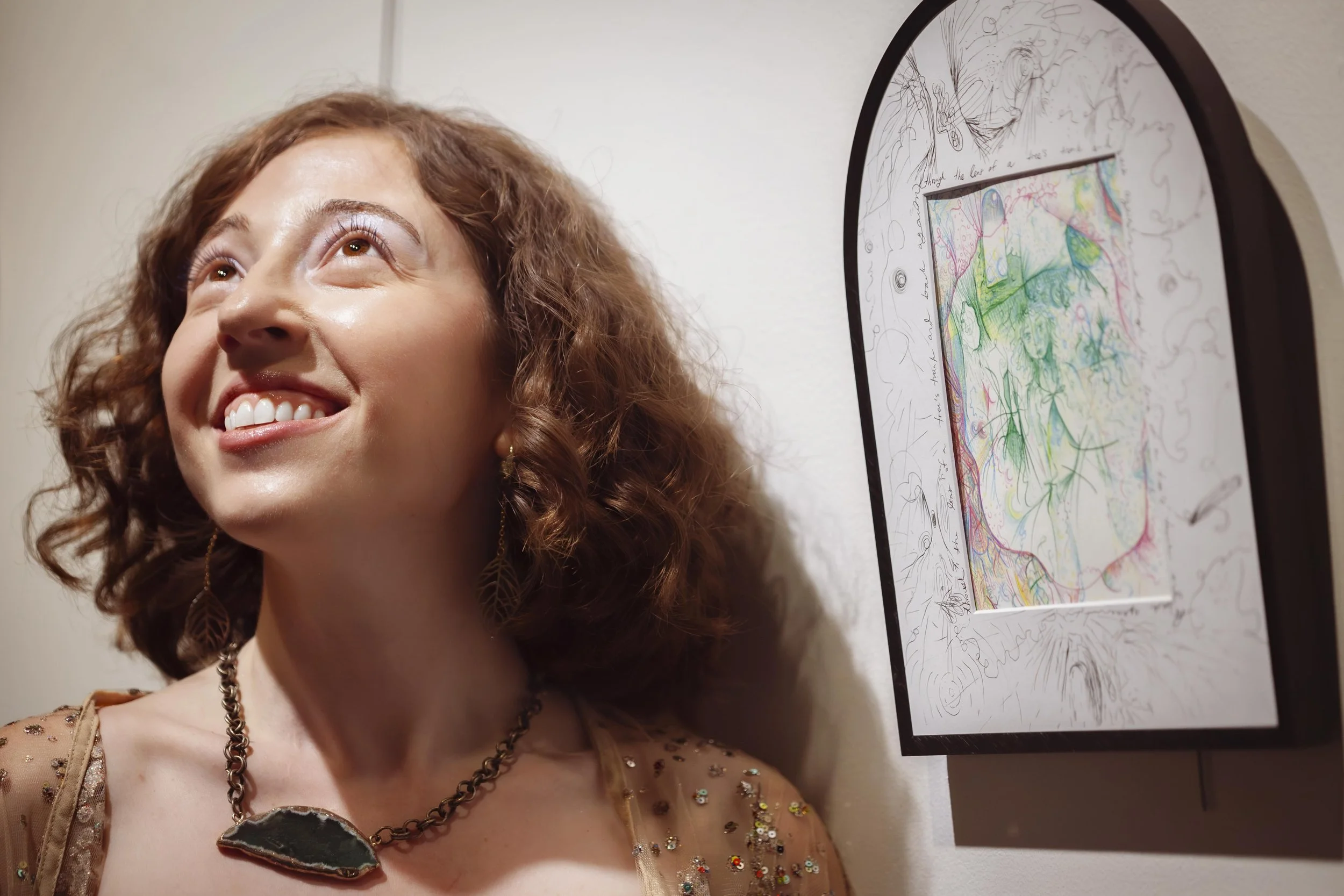 nicole-javorsky-smiling-with-her-artwork.jpeg