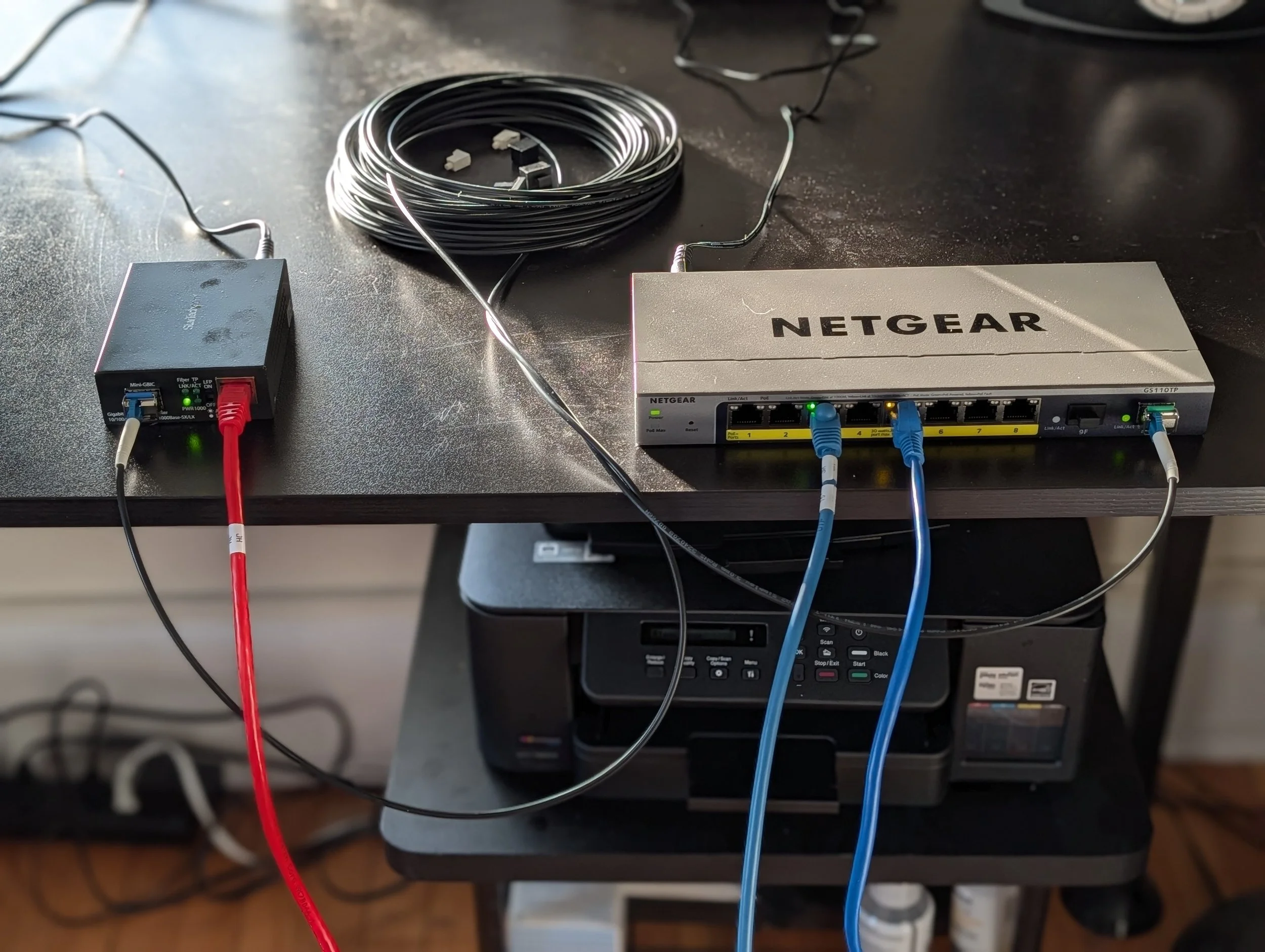 Fiber optic cable connected to a network switch and media adapter