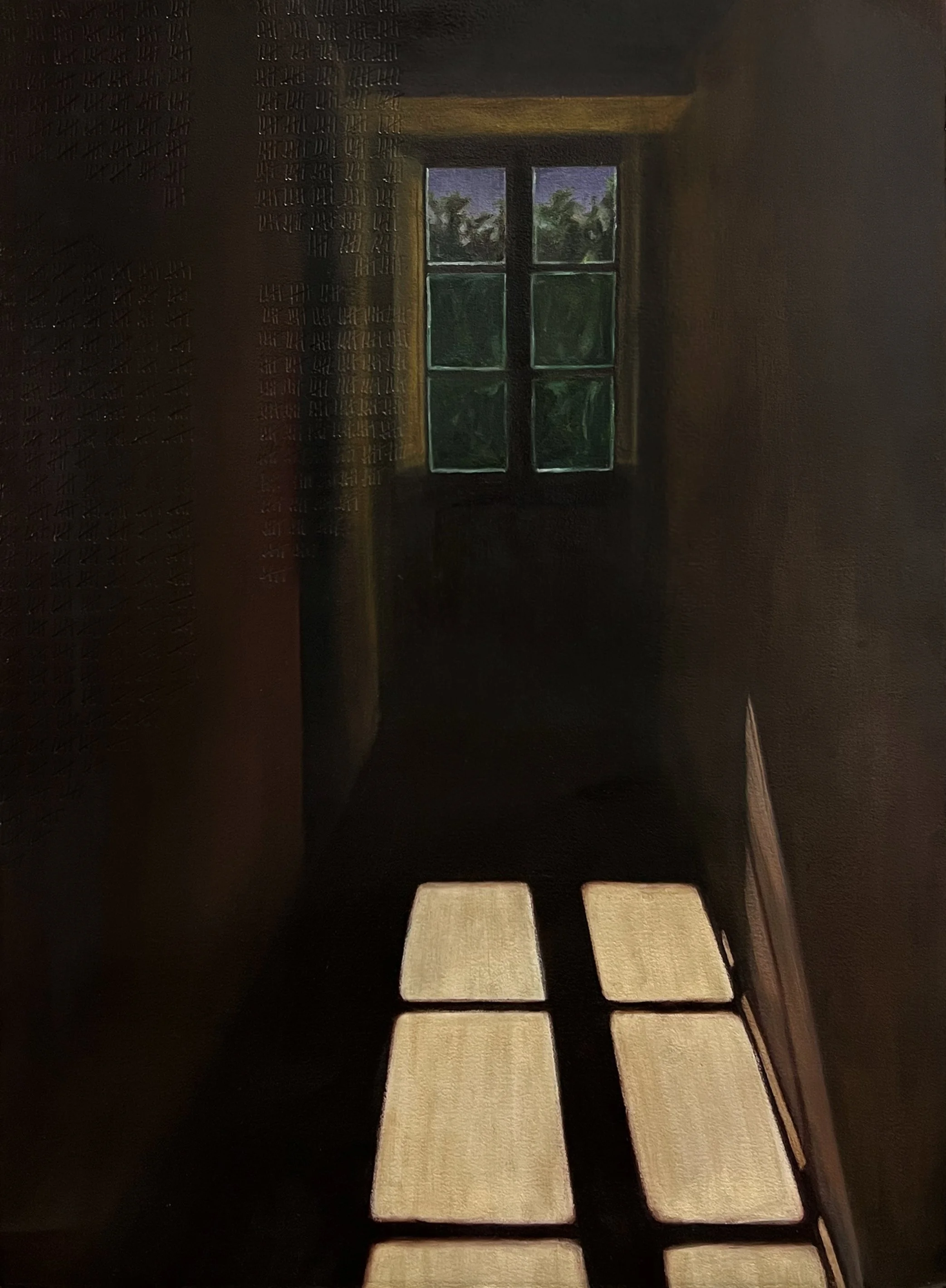 Looking down a hallway at night, a window at the end of the hall is looking out on green trees.