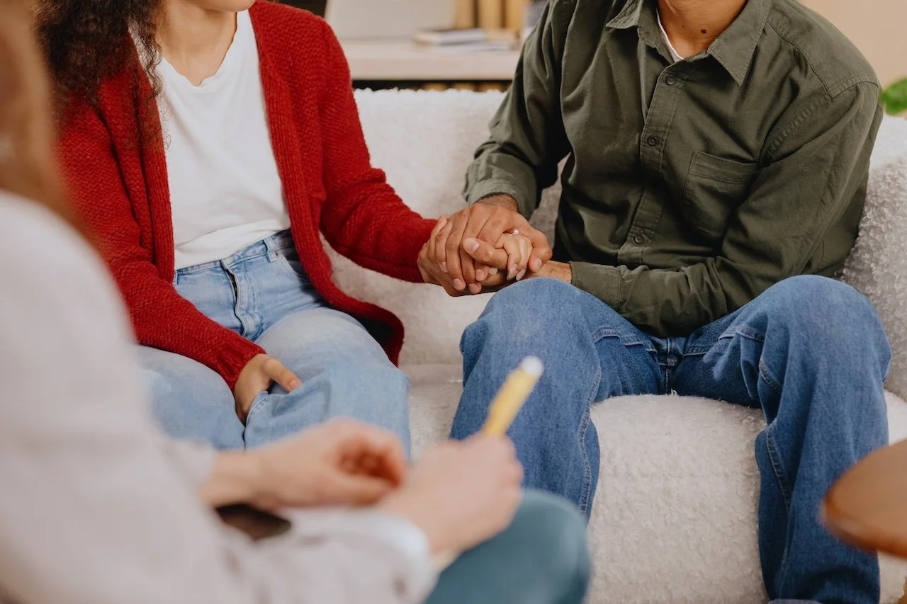 Engaged couple holding hands during a premarital counseling session in Phoenix AZ