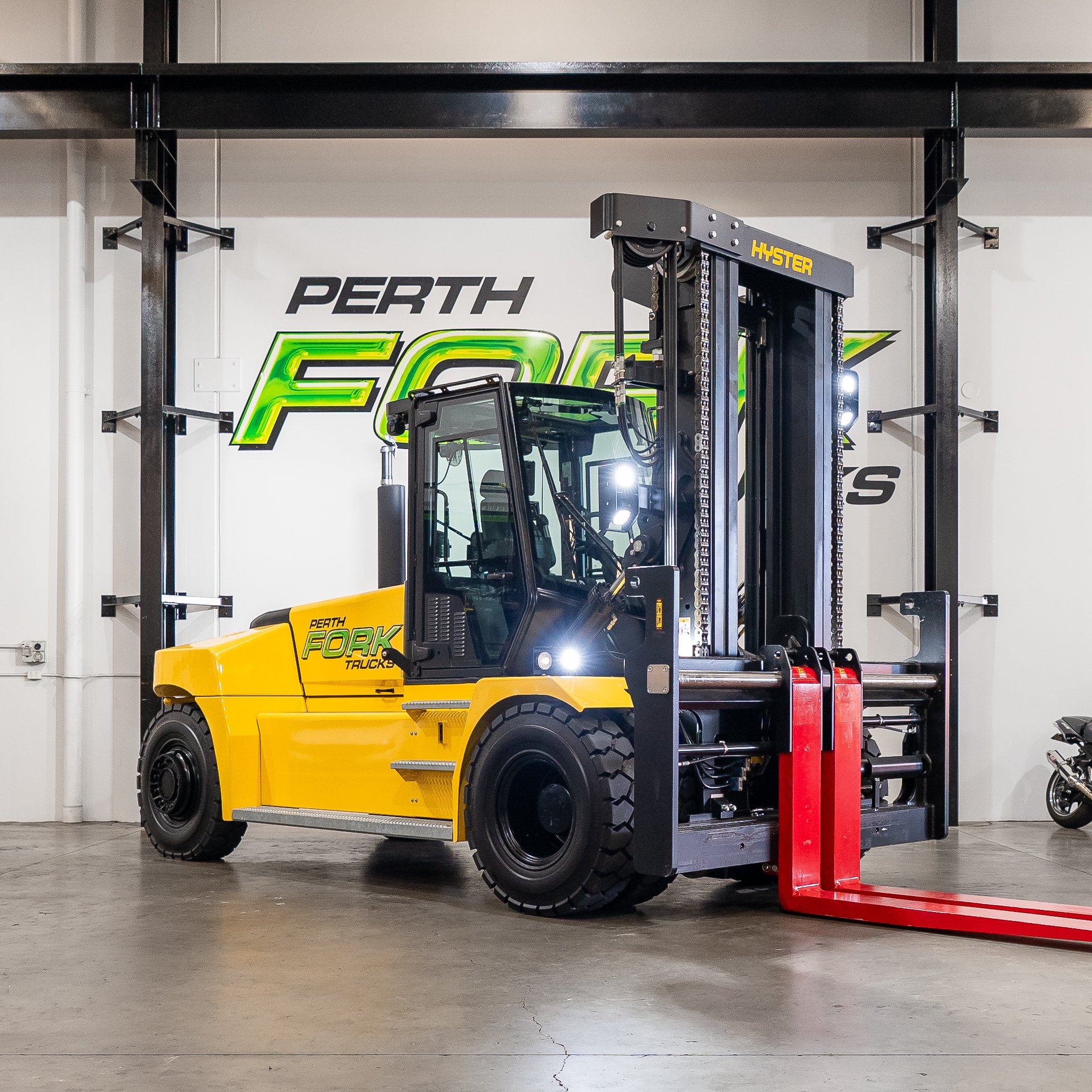 Yellow Hyster forklift parked indoors at Perth Fork Trucks garage.