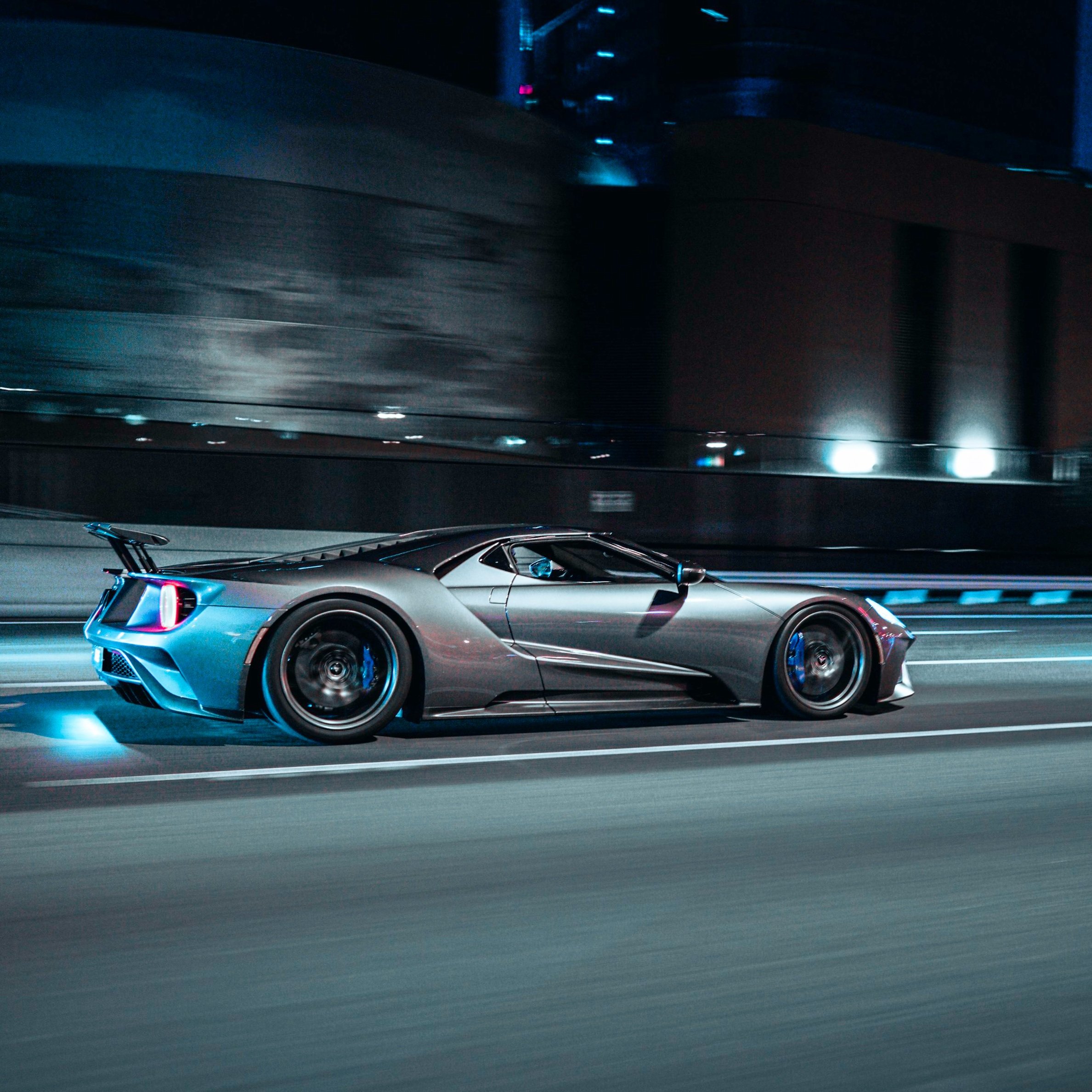 Sportscar driving on a city street at night, motion blur effect
