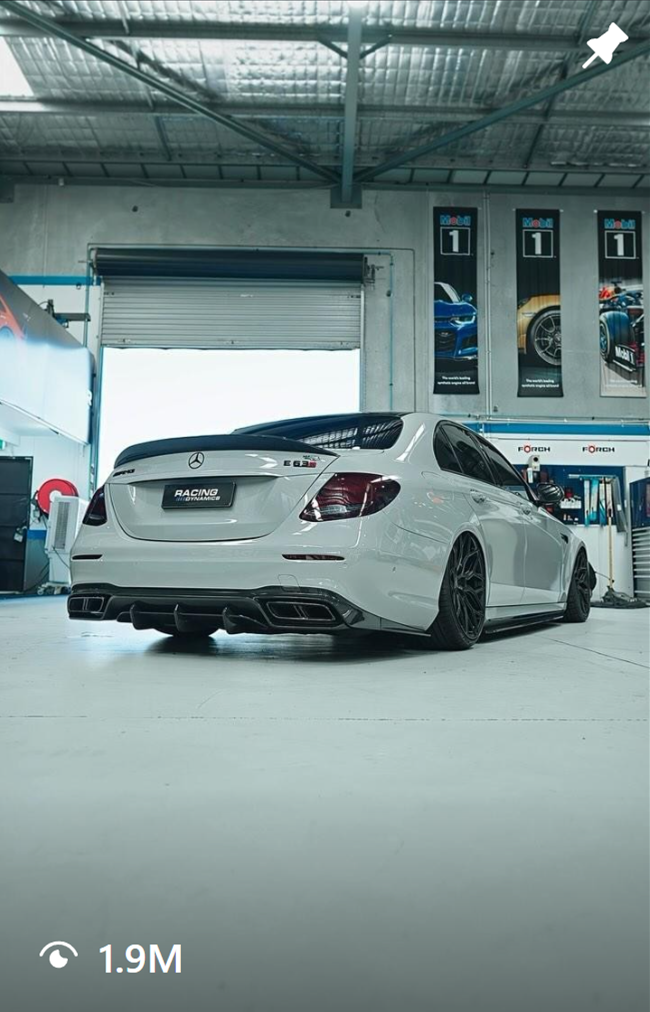 Thumbnail of a video showing a custom grey Mercedes-Benz E63S sedan with black wheels in a mechanical workshop. The video has 1.9 million views on the Instagram UI.