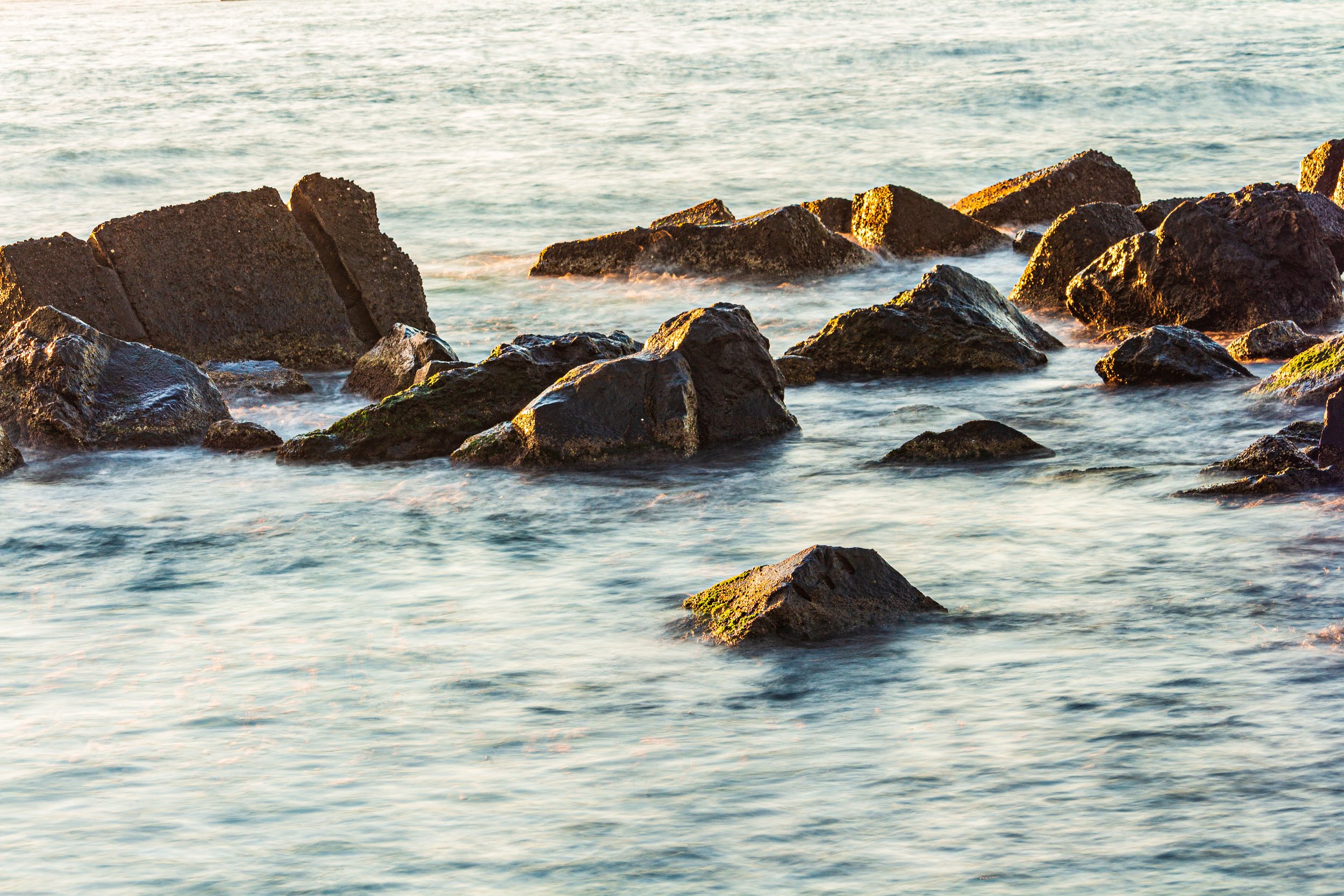 Rocas en el mar con agua moviéndose alrededor.
