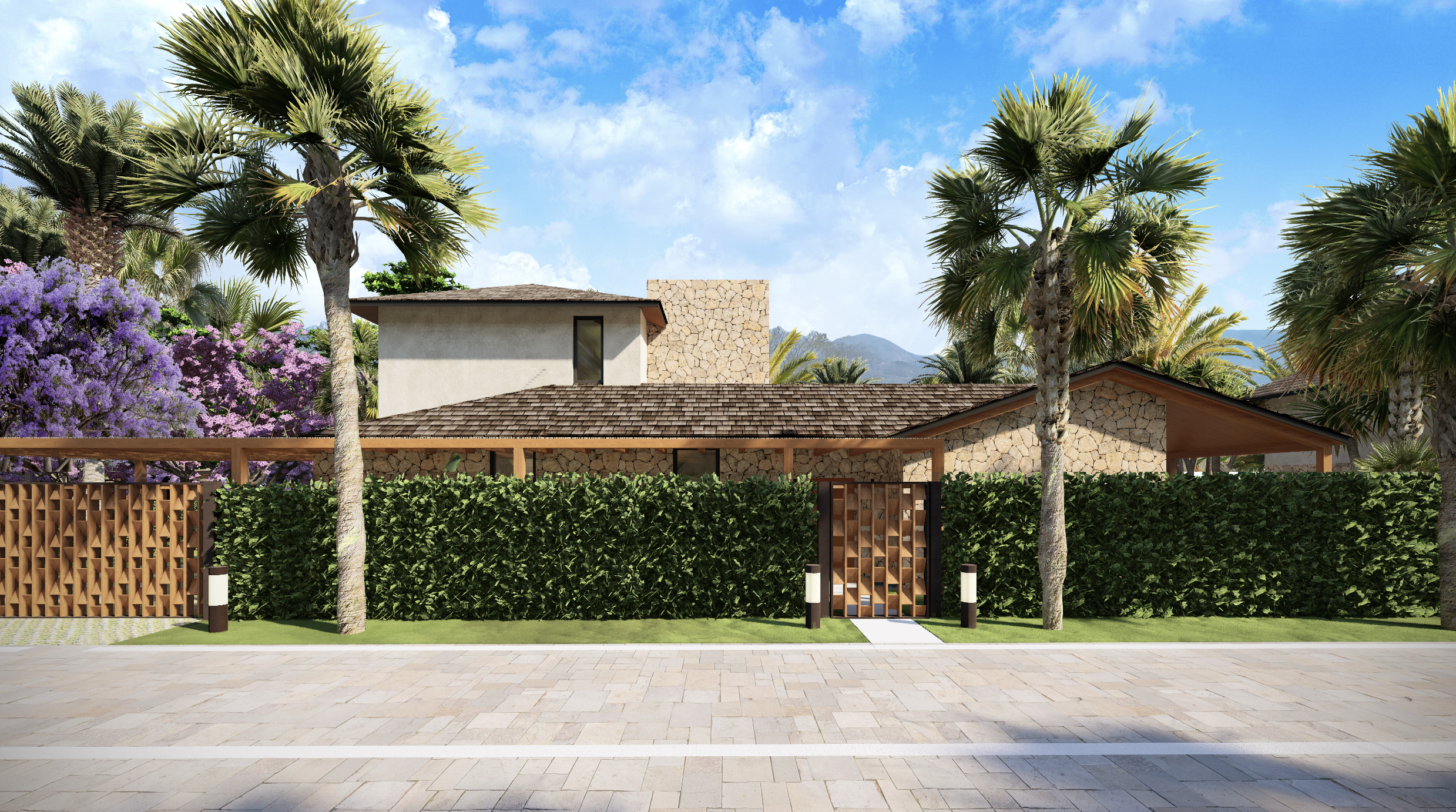 Casa moderna con fachada de piedra, rodeada de palmeras y arbustos verdes en un entorno tropical.