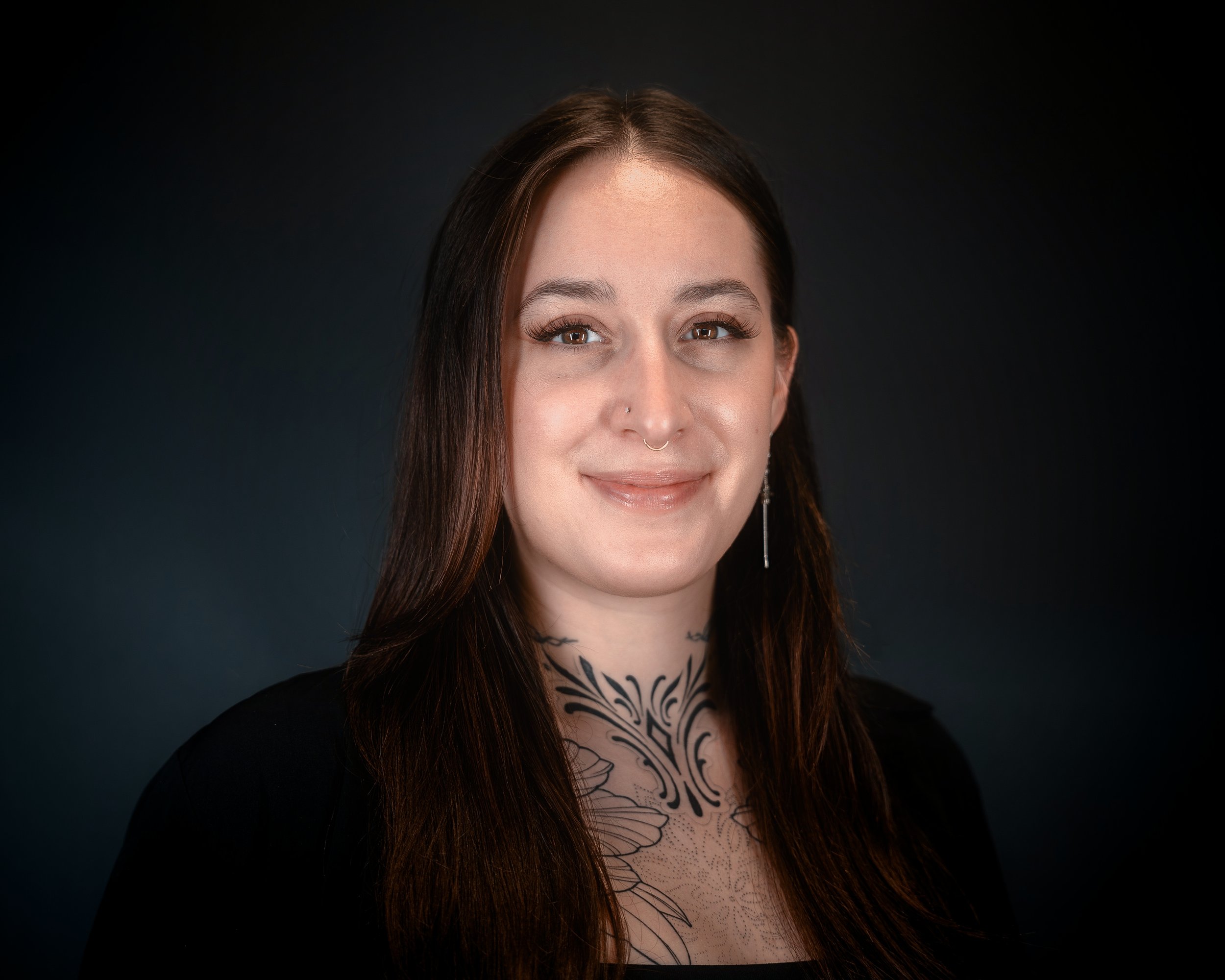 person with tattoos smiling 