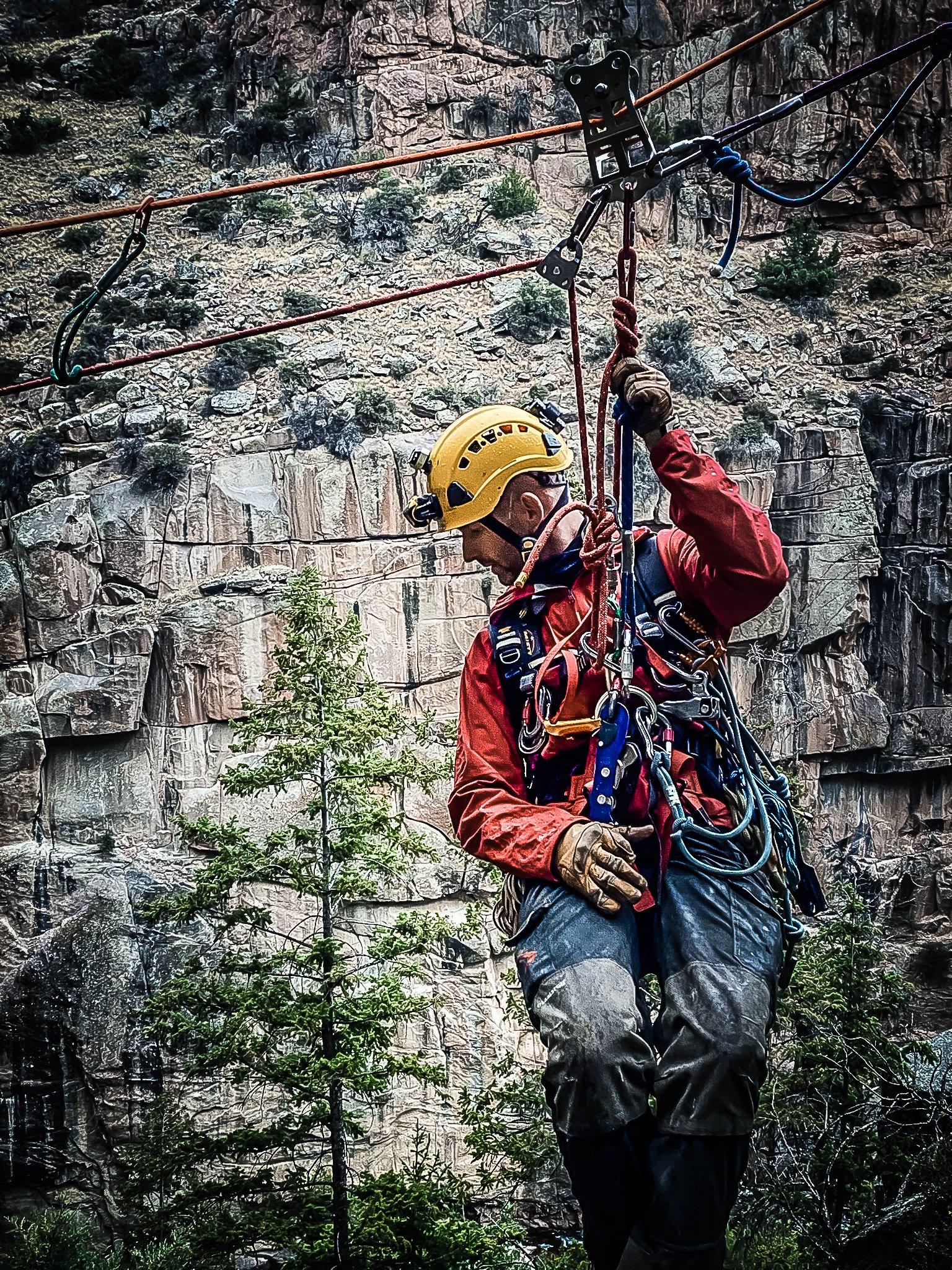 Rope Rescue Technician hangs from a highline system over a void in Wyoming