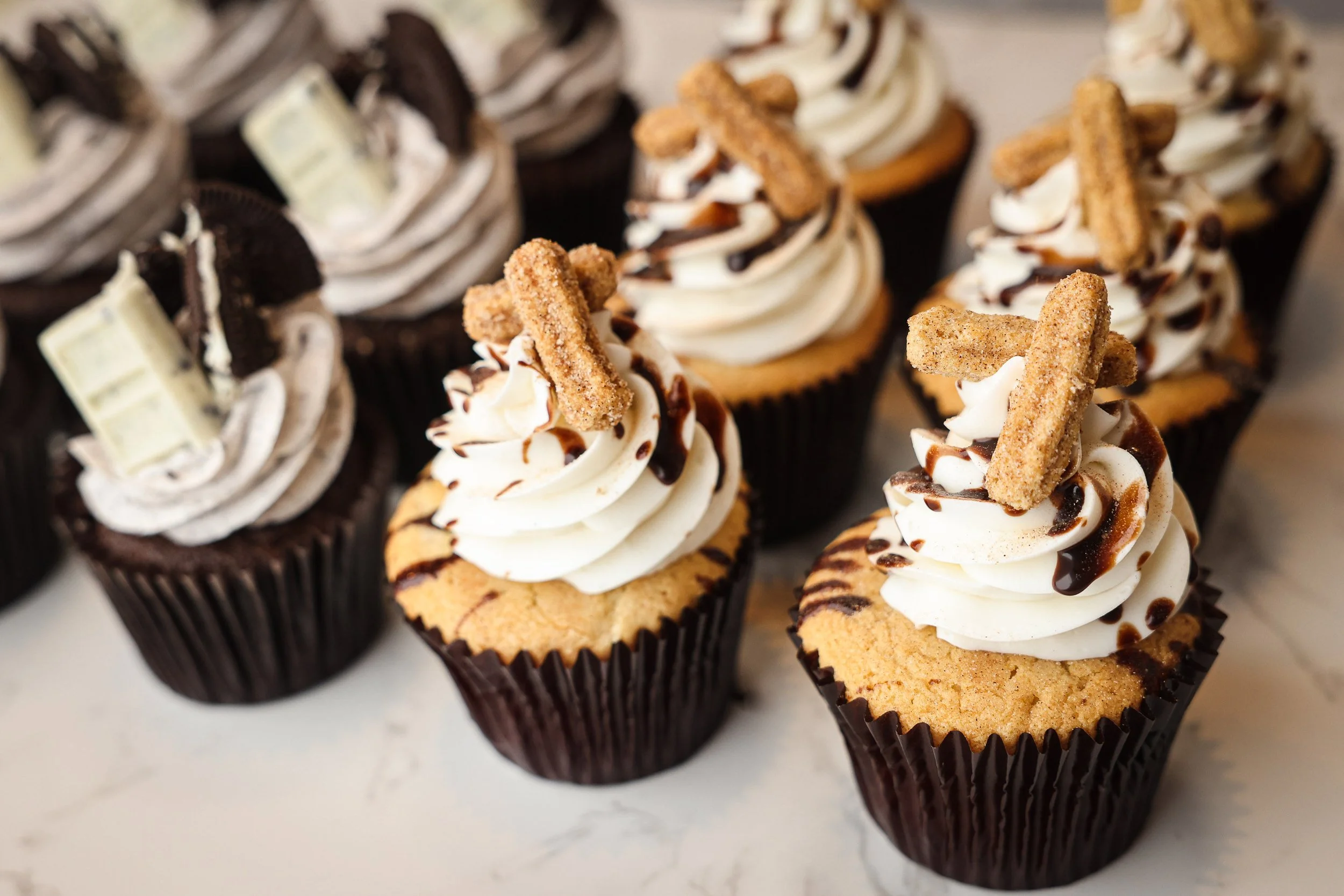 Nonalcoholic Vegan Dozen Cupcakes with a Half Dozen Chocolate Cookies and Cream and another Half Churro Caramel