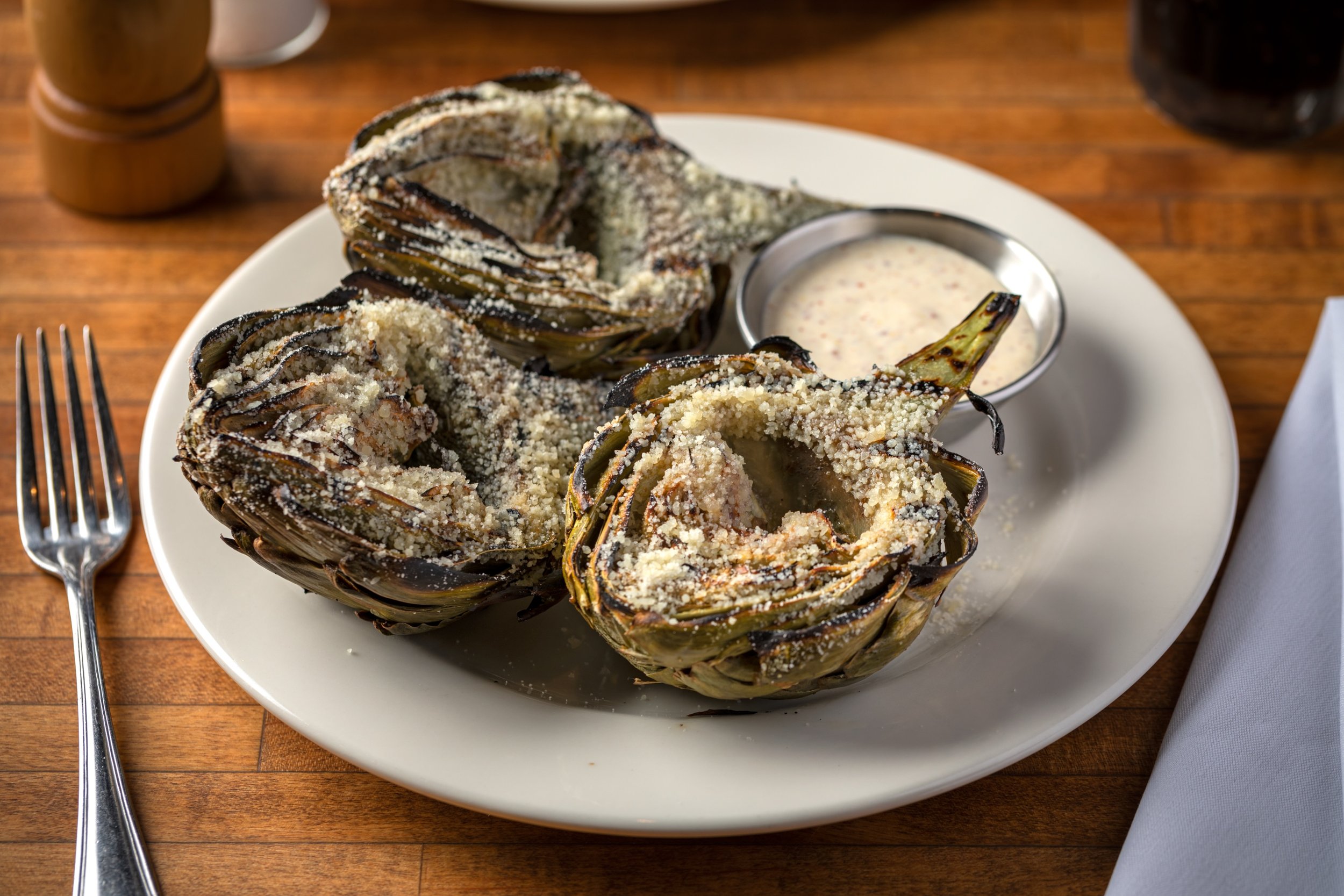 Grilled to tender perfection, dusted with freshly grated Parmesan, and served with our house made aioli - our artichoke appetizer is the perfect start to a marvelous meal! 
.
.
.
#grilledartichoke #whitechocolategrill #artichokeapp #wcgrill
