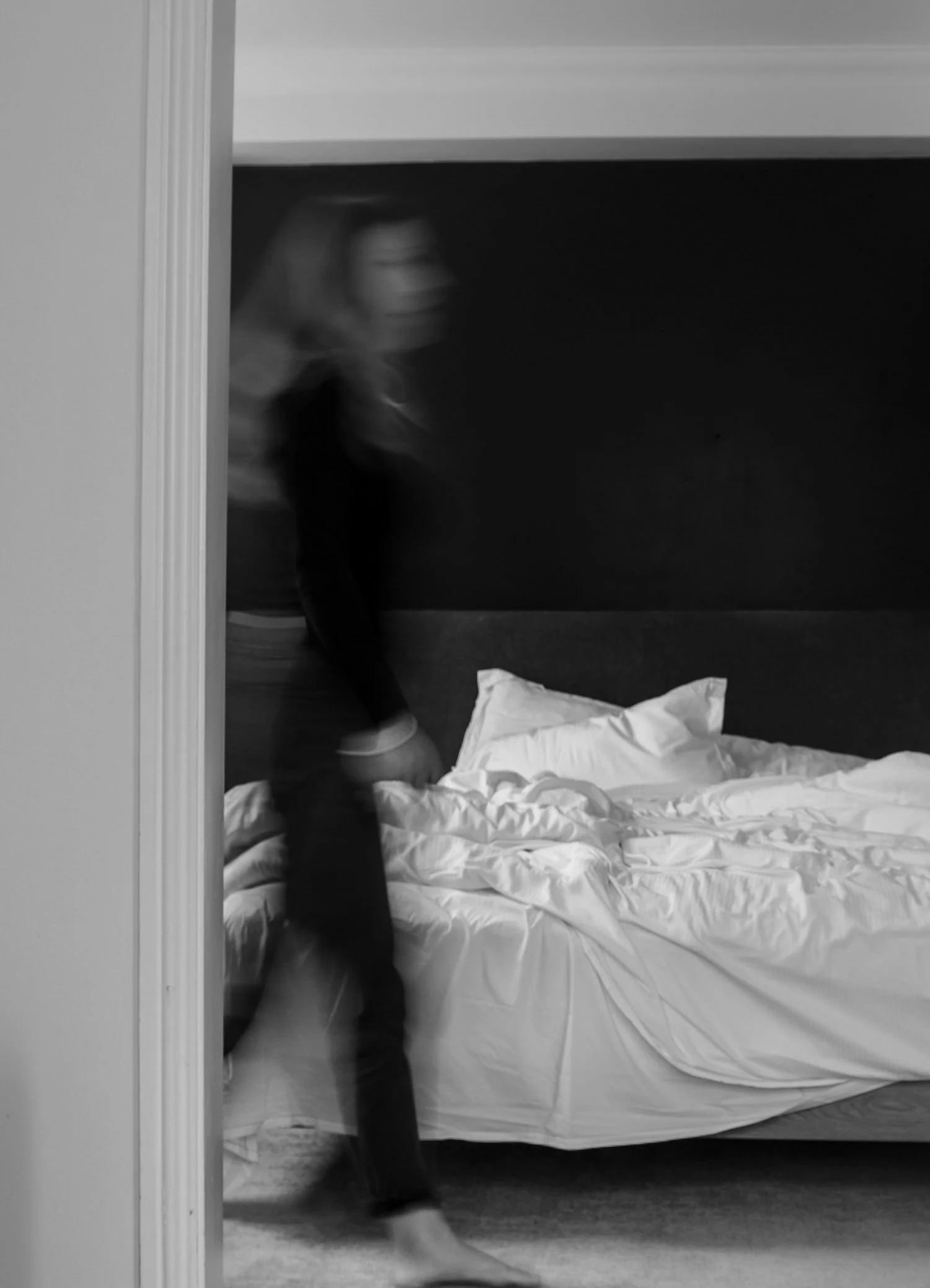 Woman walking through bedroom