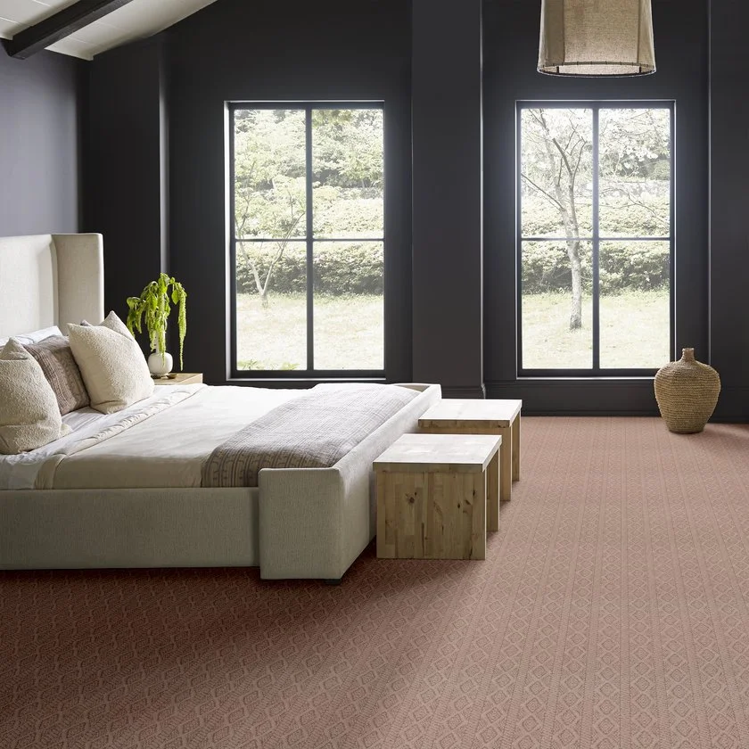 A moody bedroom with Adnerson Tuftex's Crochet carpet, with a pink color, installed for the carpet