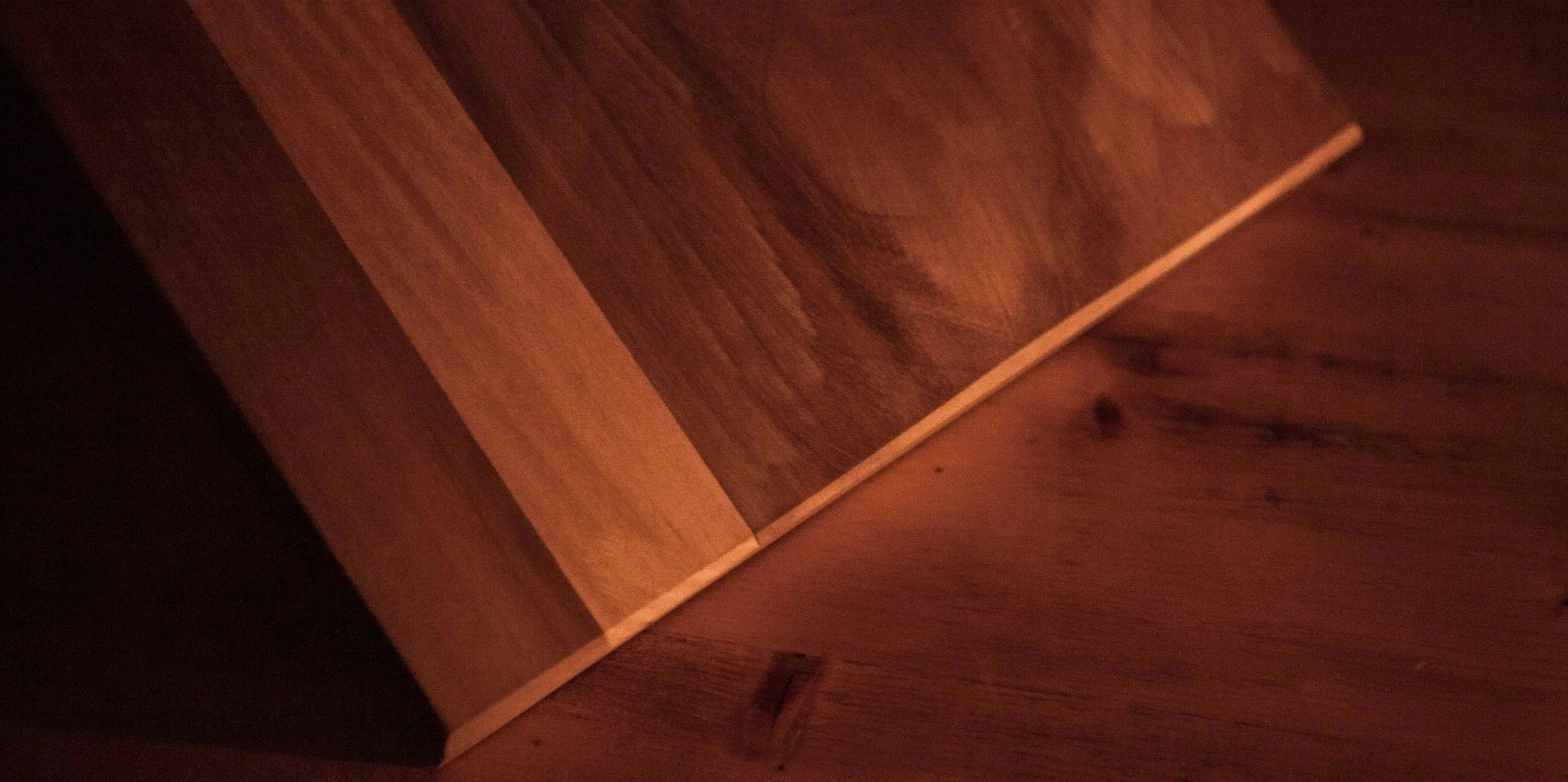 Planks of red walnut glued together. The walnut wood is red in color