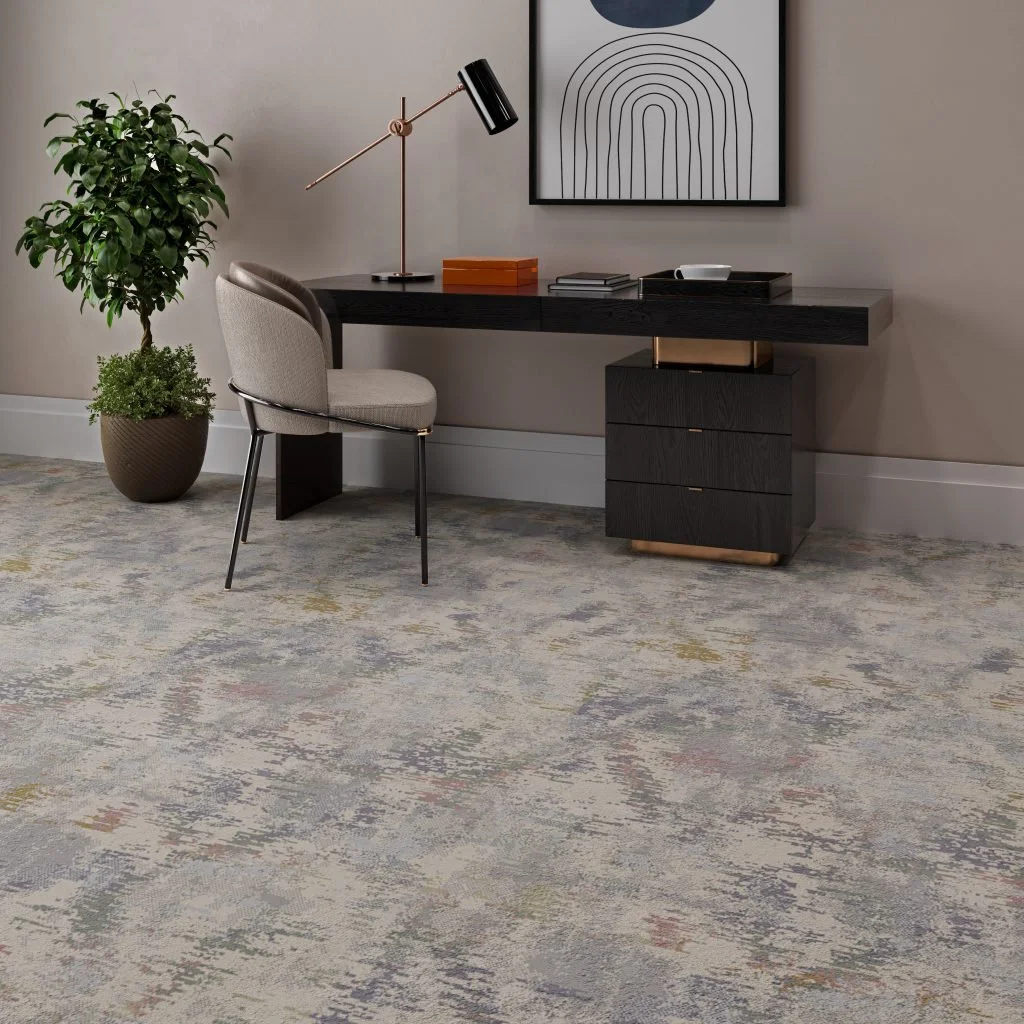 Kane Carpet Adventure in the color Happening is installed in a small home office, which highlights the use of colors within the carpet itself.