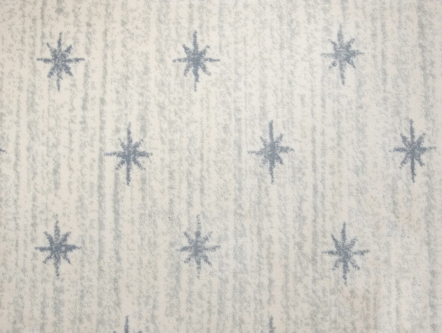 Light colored carpet with light blue stripes and darker blue stars 