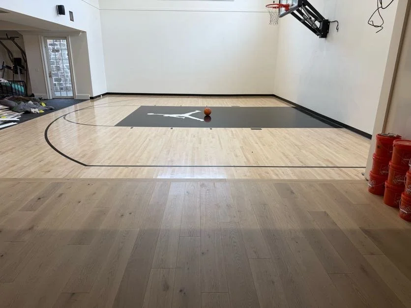 Newly finished home basketball court in a basement of a luxury home.