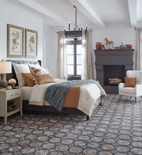A bedroom with the primary vocal point the carpet, which is Masland's Scotland in Midnight