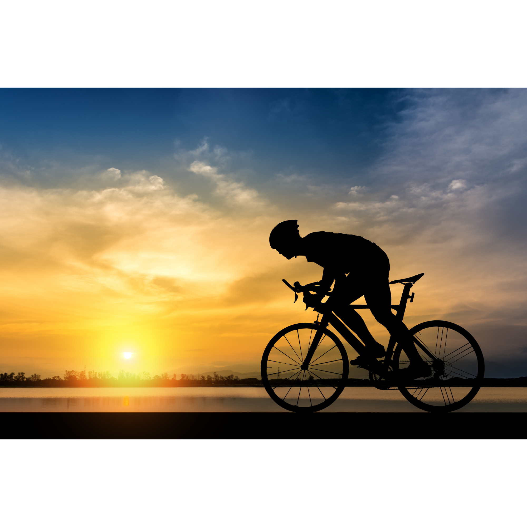 Road cyclists on a bike path around a lake with a sun setting in the background