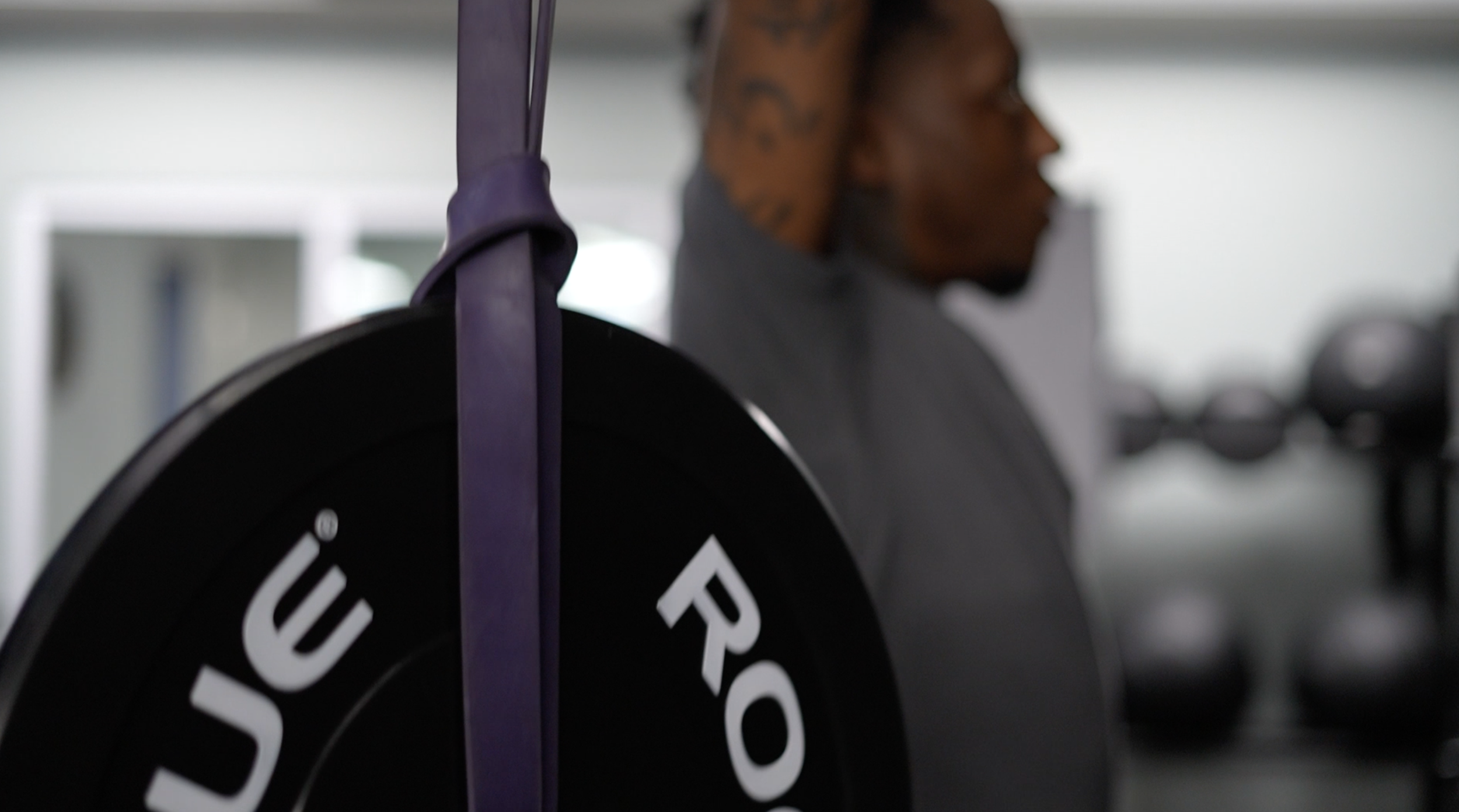 male performing an overhead press as part of his physical therapy program.