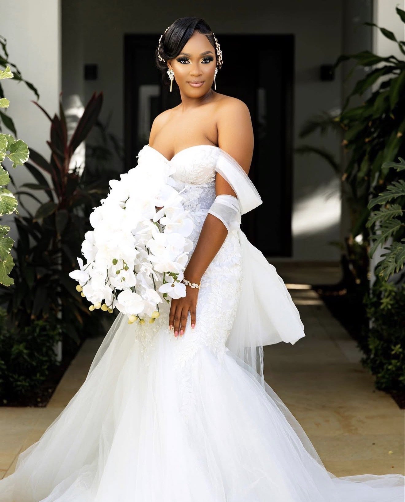 A bride on her wedding day holding a bouquet.