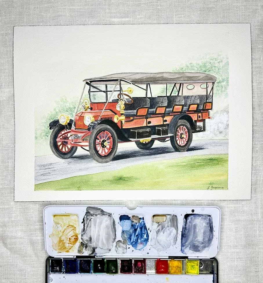 A watercolor painting of an old vintage car parked on a road with greenery in the background, and a watercolor palette below.