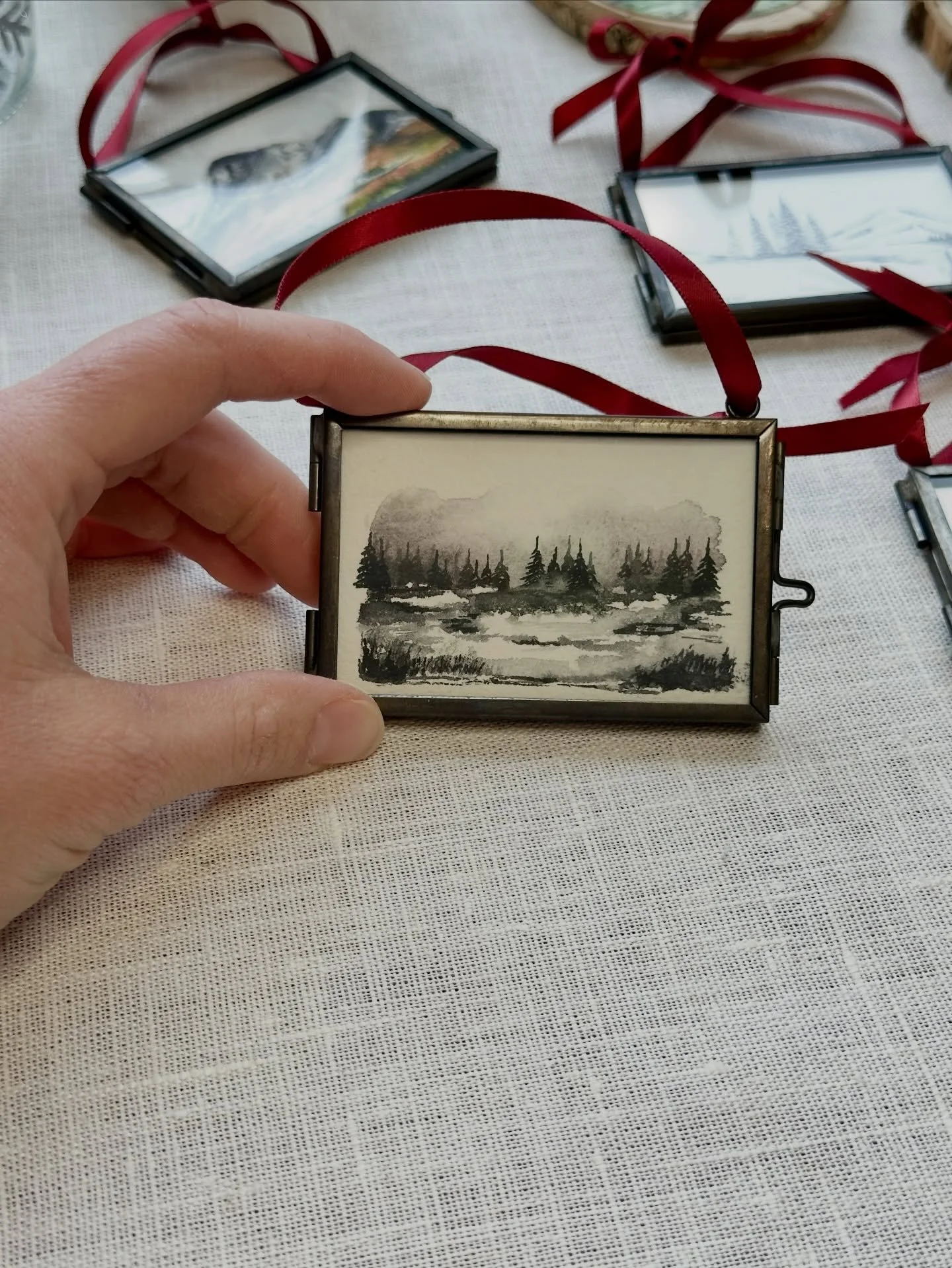 Creating homemade holiday ornaments each year is now one of my favorite traditions. Each year is a little snapshot in time of my painting style and what I am inspired by. My 2025 ornaments are moody watercolor landscapes. They make me think of winter