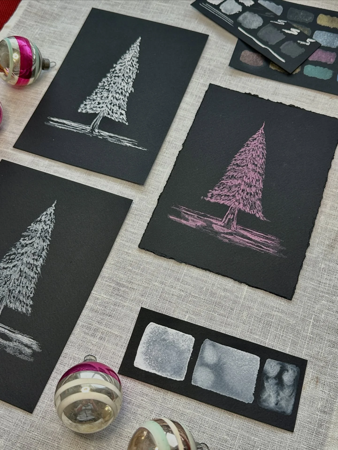 I love working on black watercolor paper when creating holiday artwork. It&rsquo;s a different surface with different texture and it is the perfect material to make white or metallic paints pop. I enjoyed creating these trees this year, but I have al