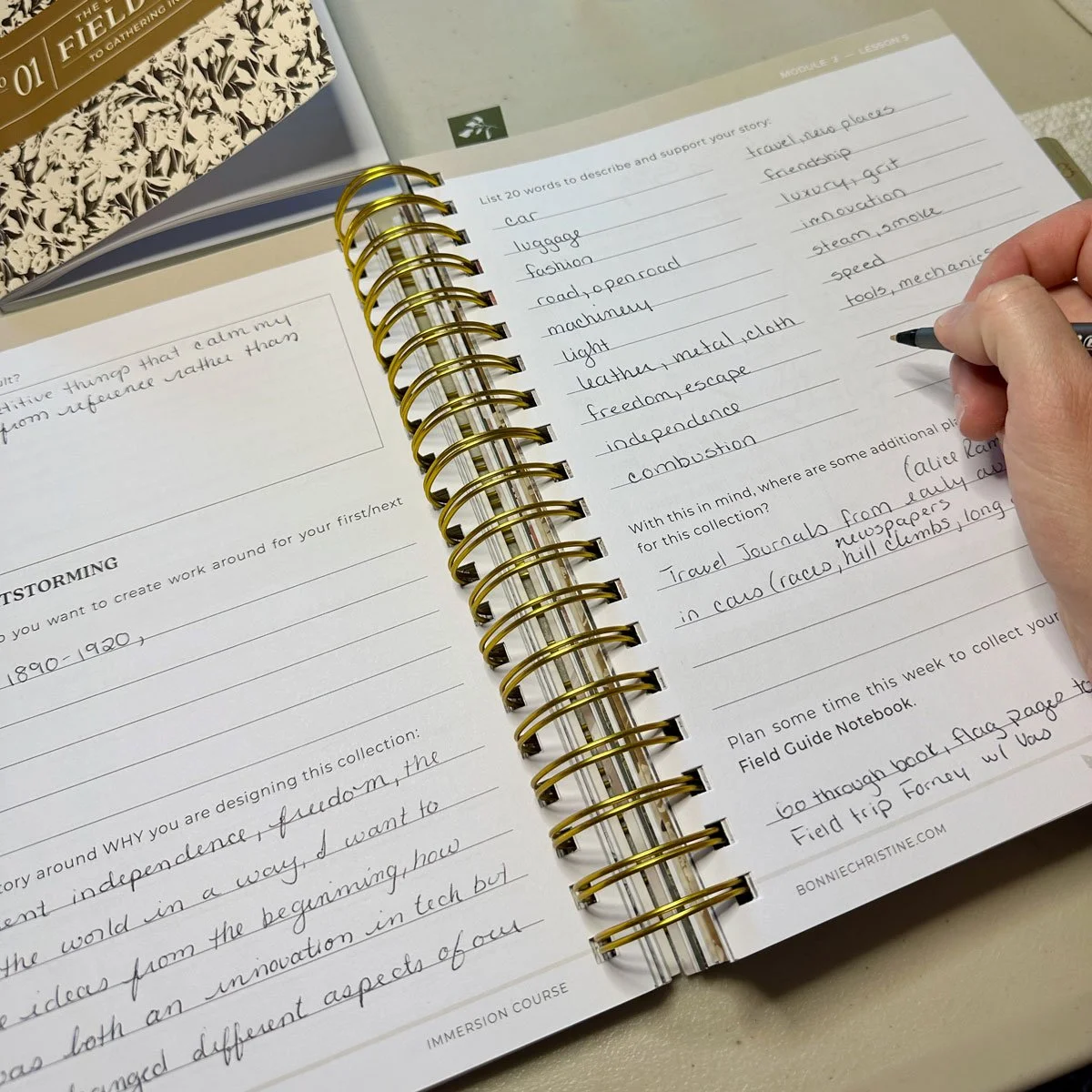 Overhead view of a hand filling out the page of a workbook