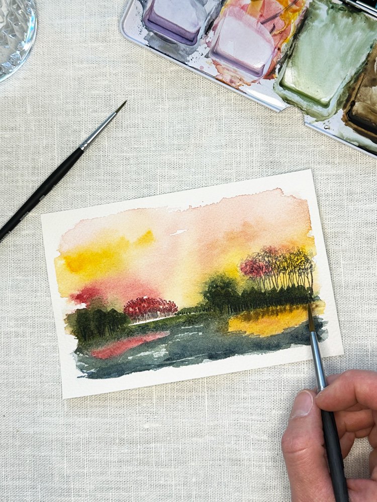 abstract watercolor scene depicting a colorful sunset