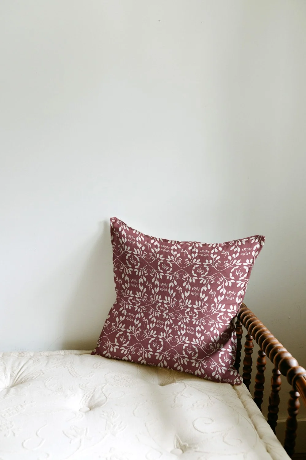 a pillow mockup with the vine geometric print in red