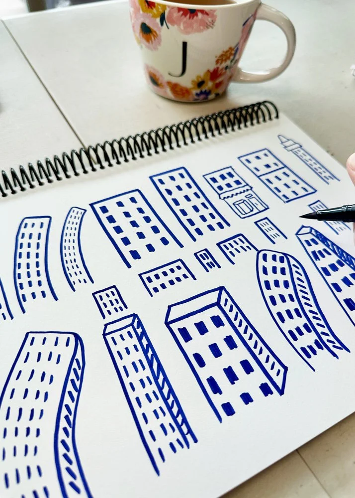 View of sketchbook page of wonky buildings