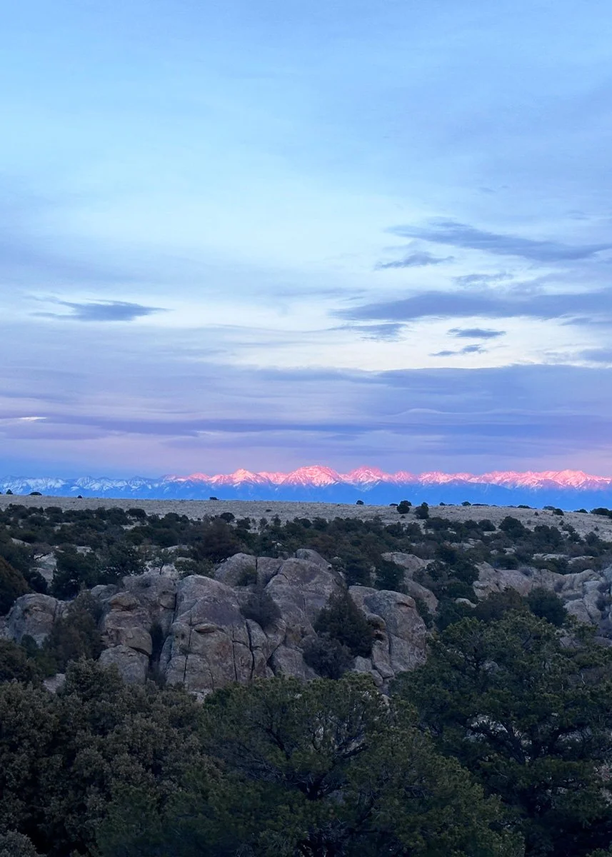view of mountain rage glowing pink at sunset