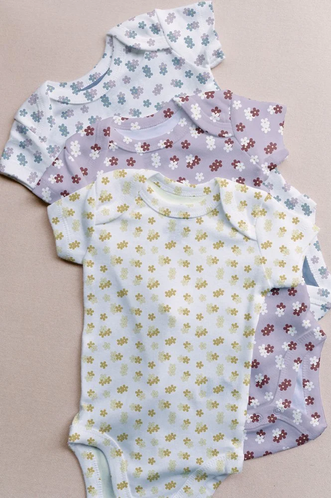 Baby bodysuit mockups featuring ditsy florals from Blush & Bloom. 