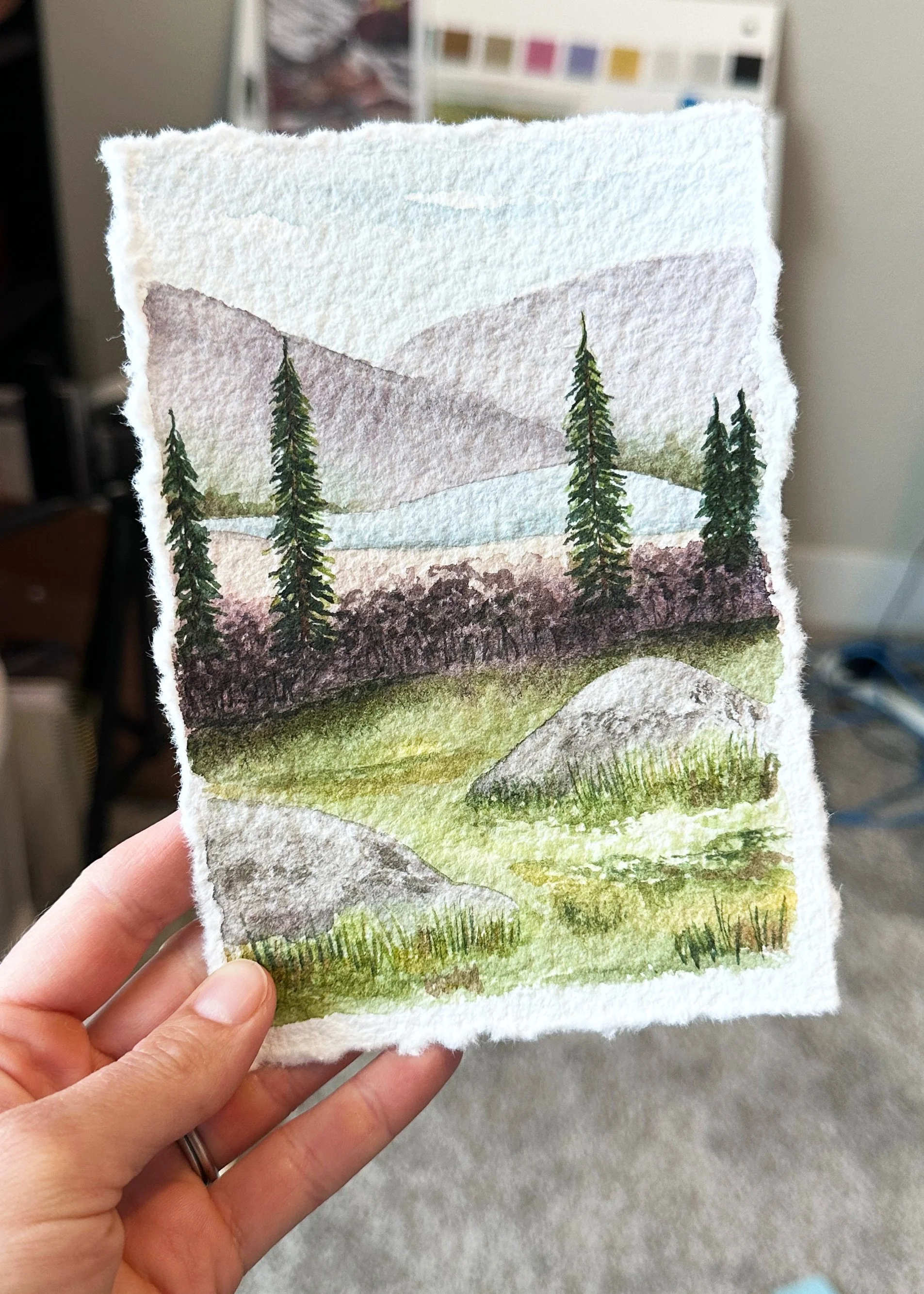 watercolor painting depicting mountains