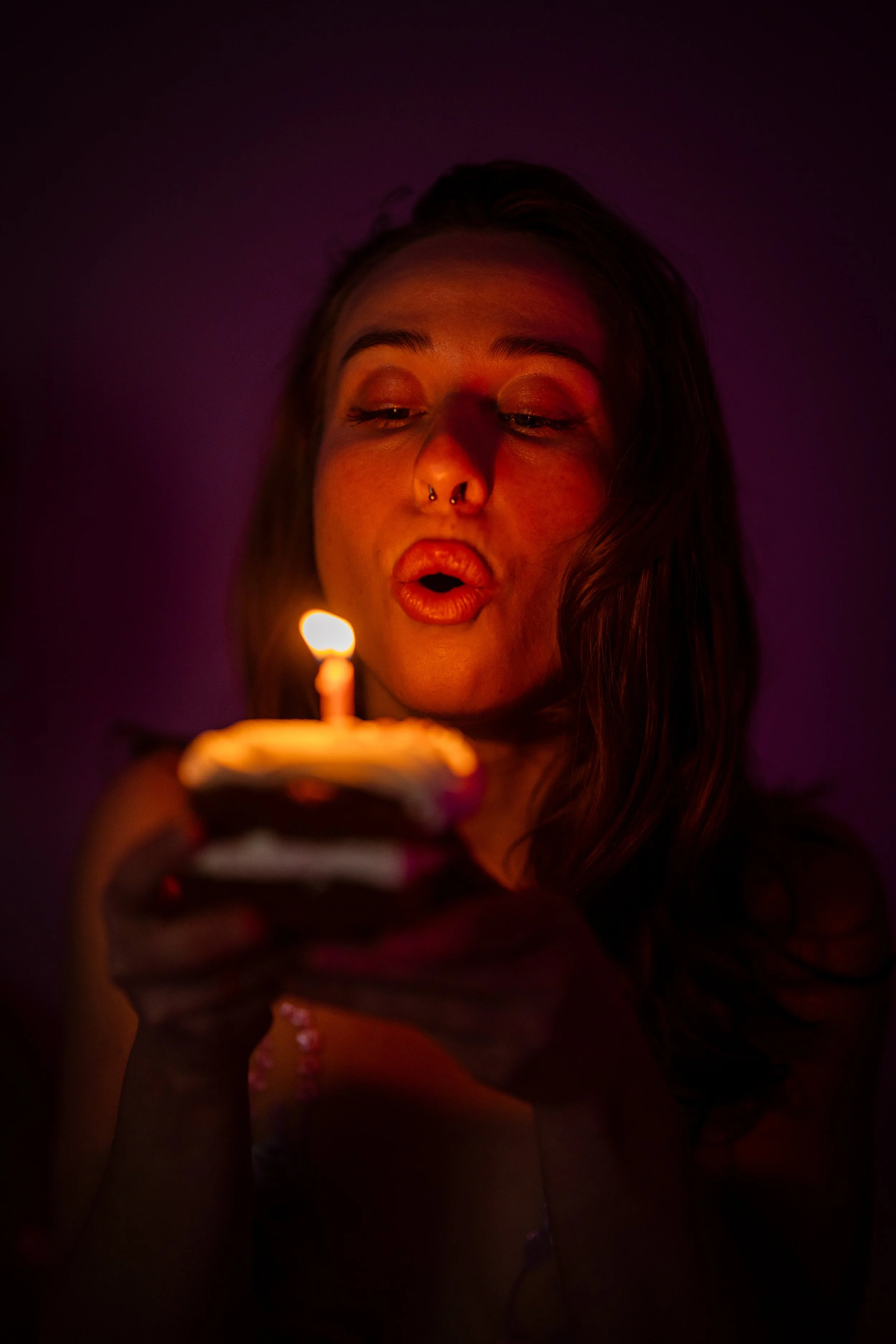 Birthday boudoir, blowing out the cake celebrating in Tallahassee Florida photo taken by Southern Peach Boudoir. 