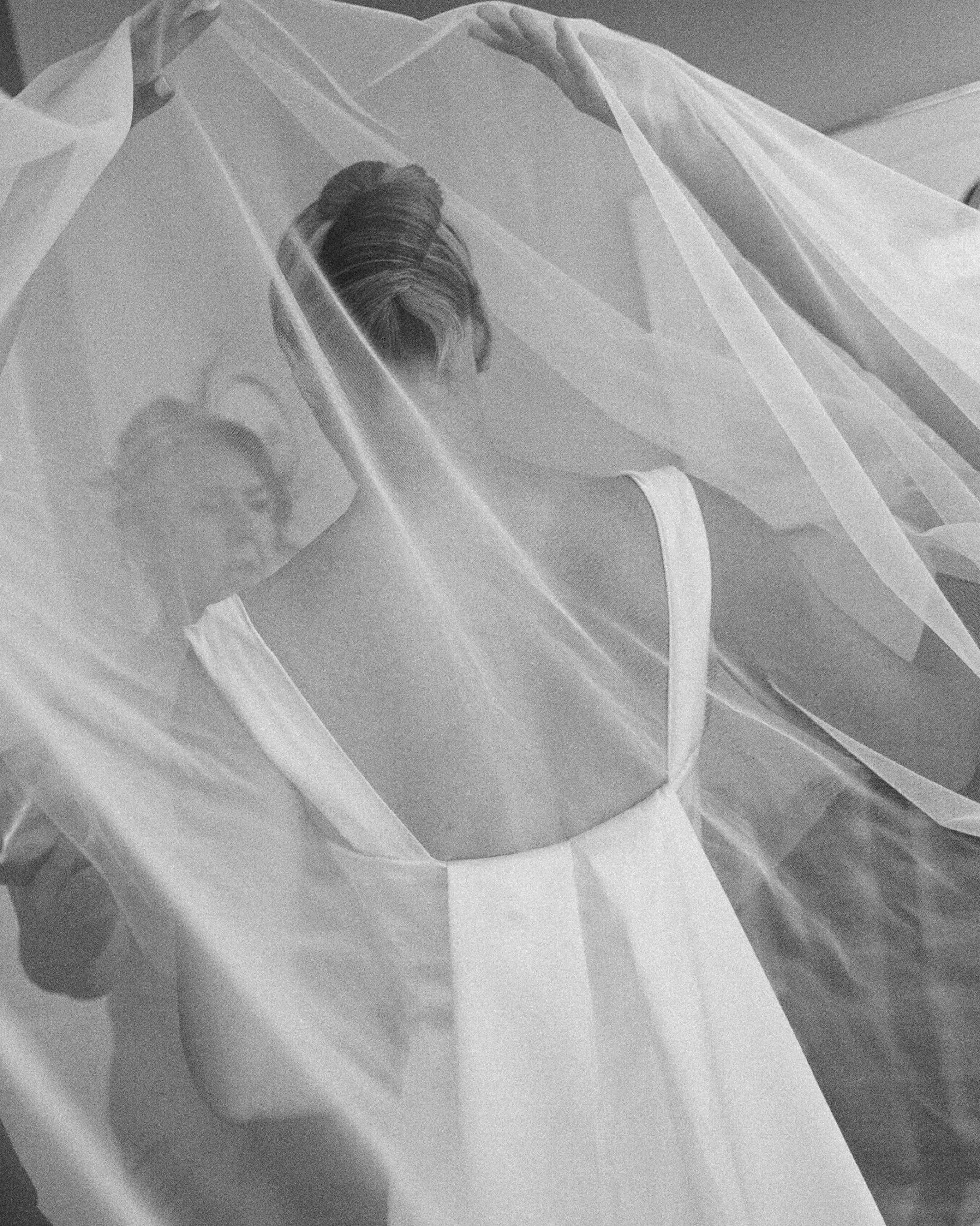 Lauren&rsquo;s dress, made by her mom, transformed throughout the day. Starting with gorgeous layers, long and flowing, she slowly shed layers as the night went on. At cocktail hour, she left her veil behind, allowing her to move about more freely. D