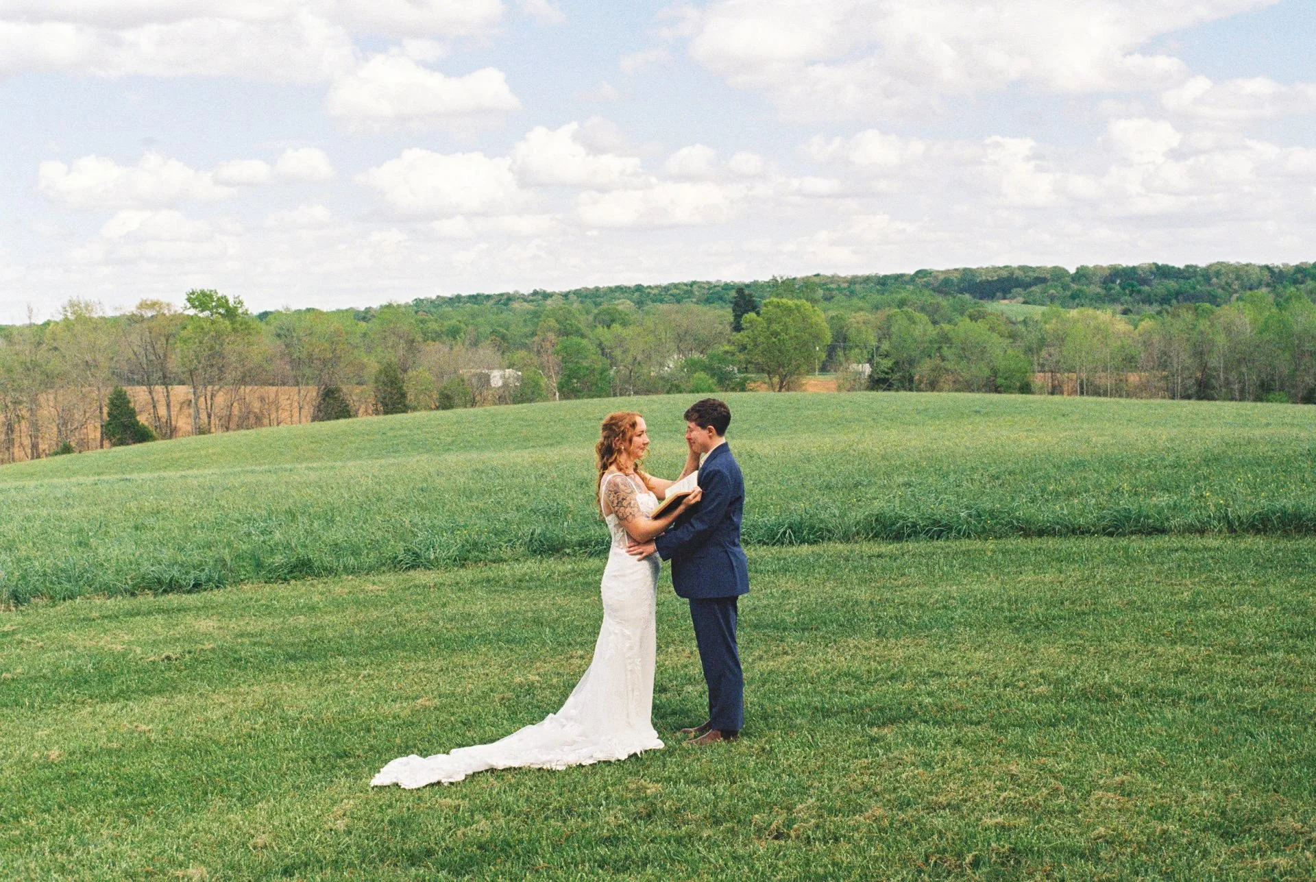 private vow moment between two brides in a field
