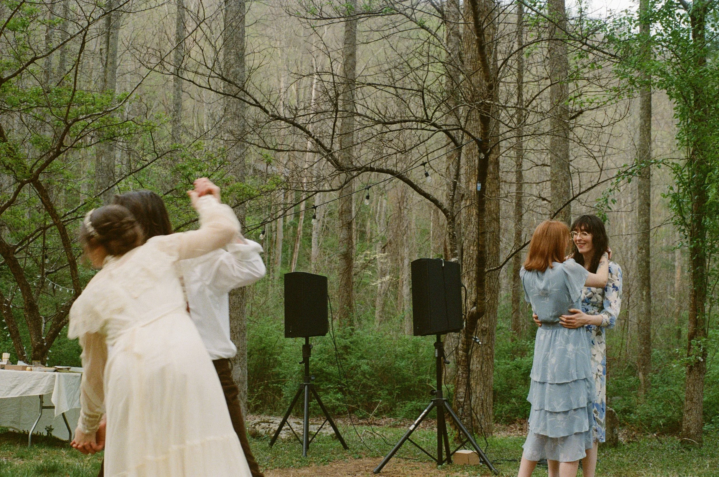 two couples dancing during outdoor wedding reception