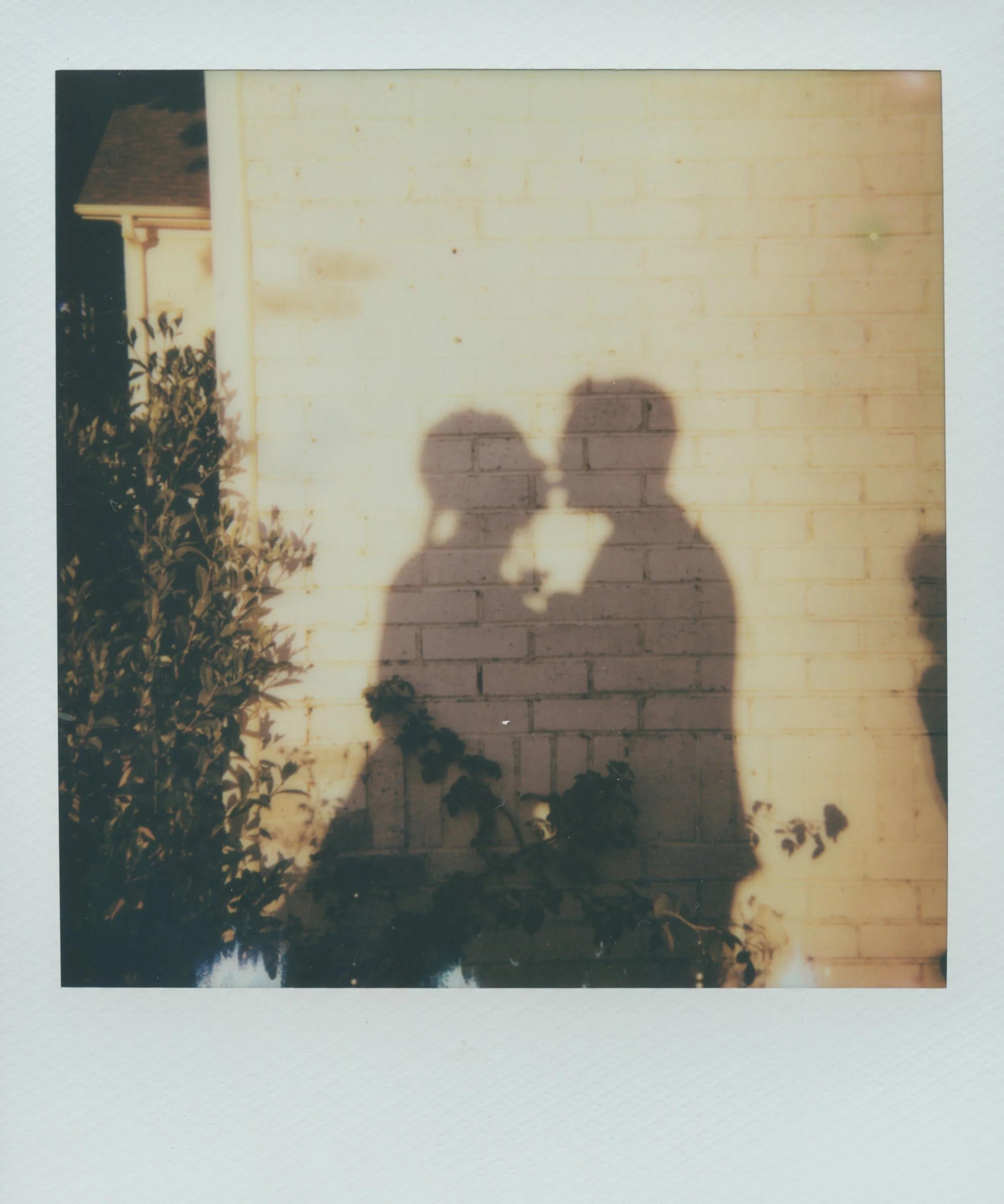shadow of a couple kissing on their wedding day on polaroid film