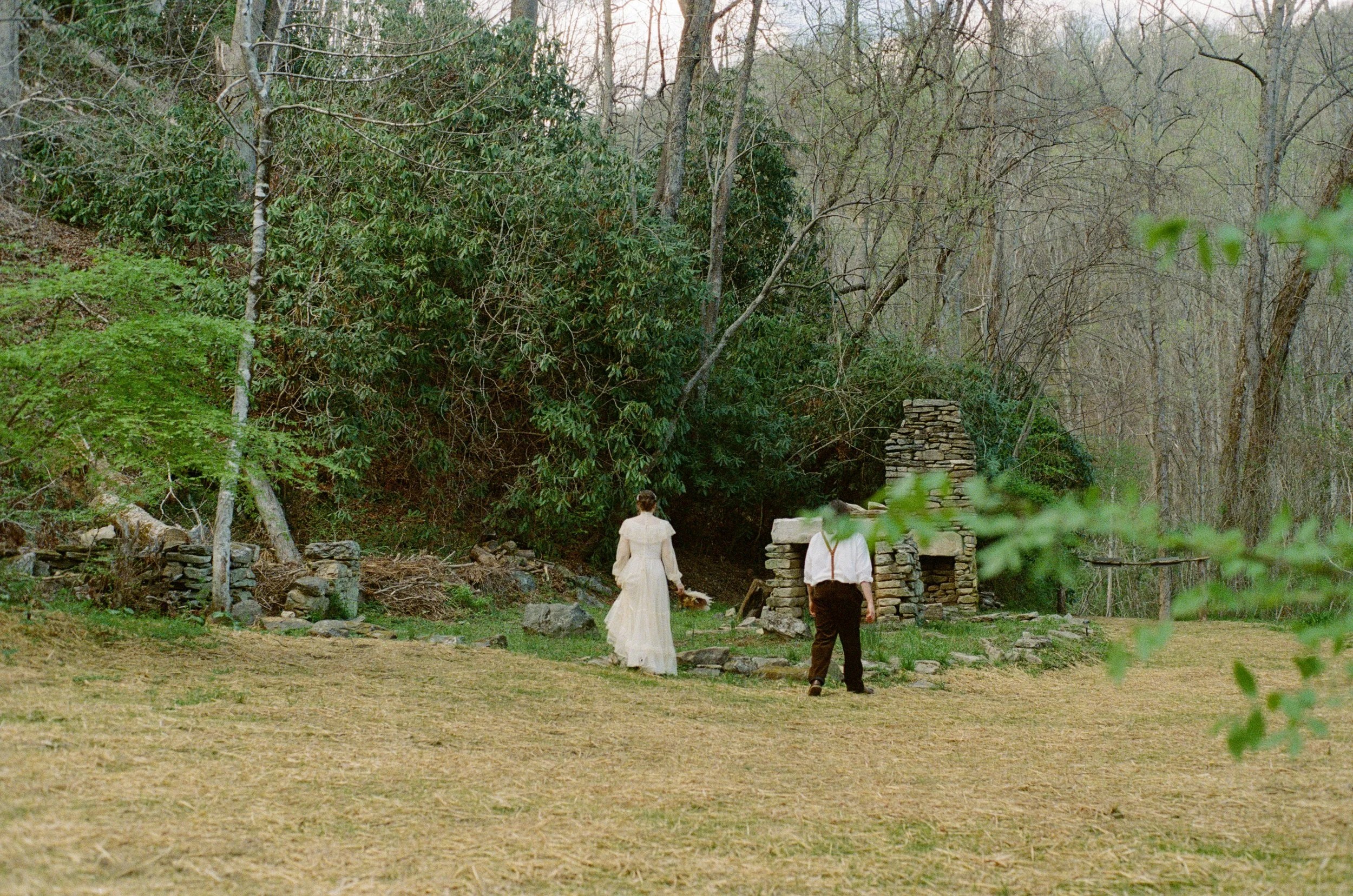 couple taking candid bridal portraits at laughing waters venue in gerton north carolina