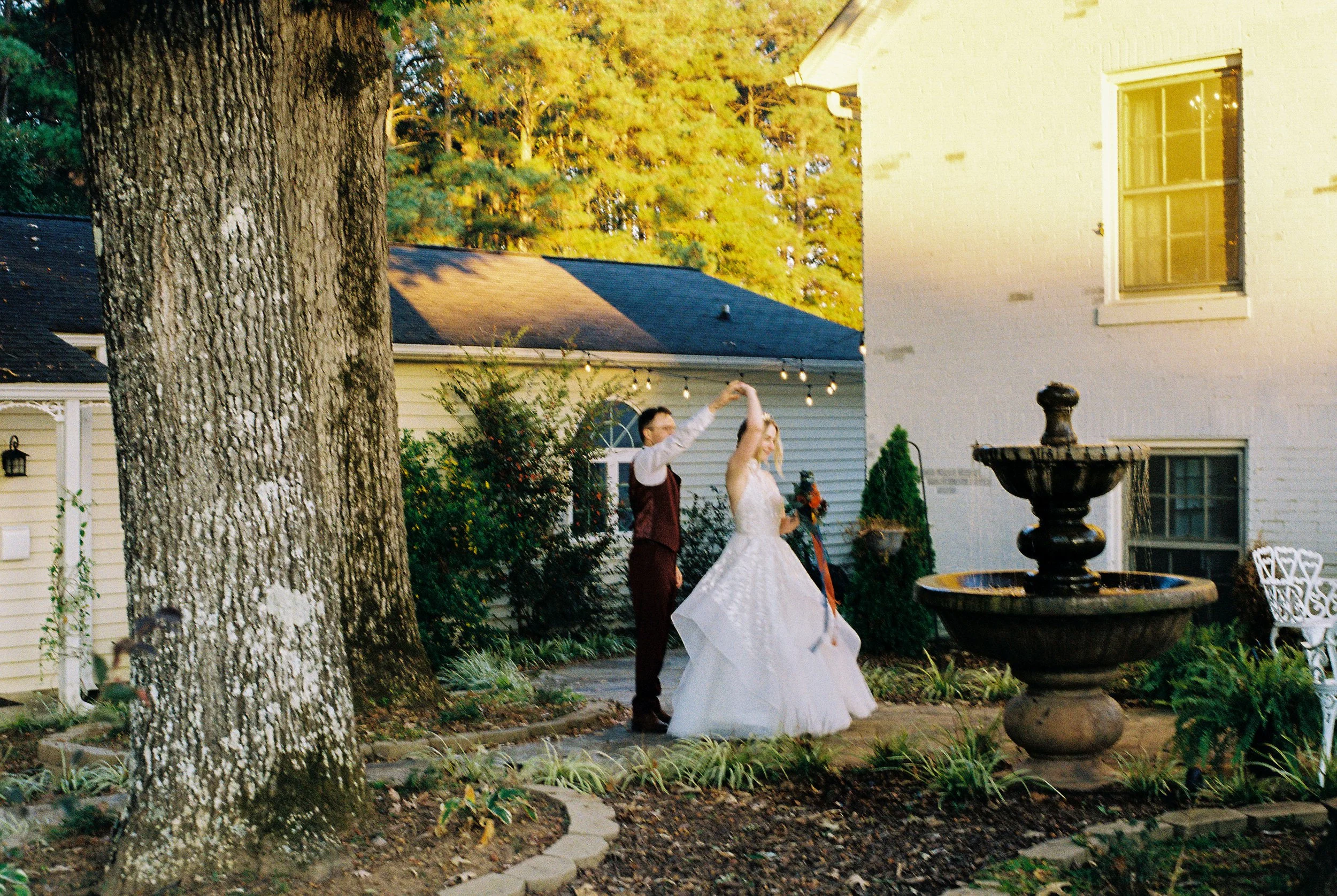 fairy tale wedding groom twirling bride during bridal portraits