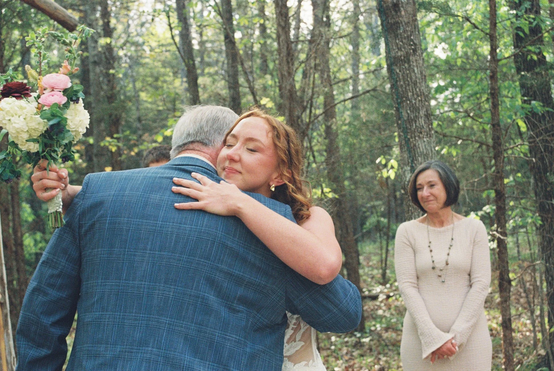 bride embracing dad as she joins partner