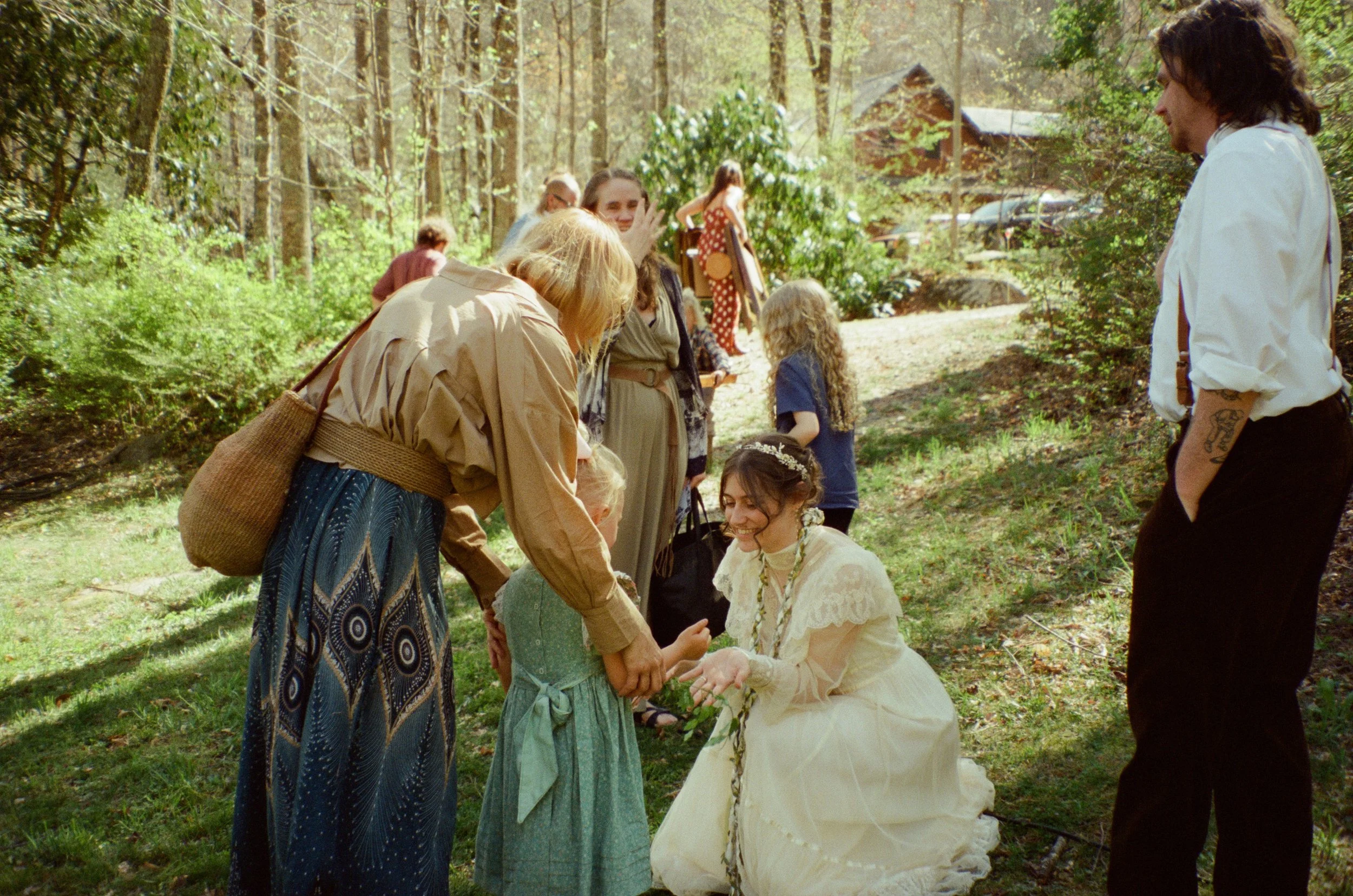 family embracing and smiling after outdoor mountain wedding ceremony