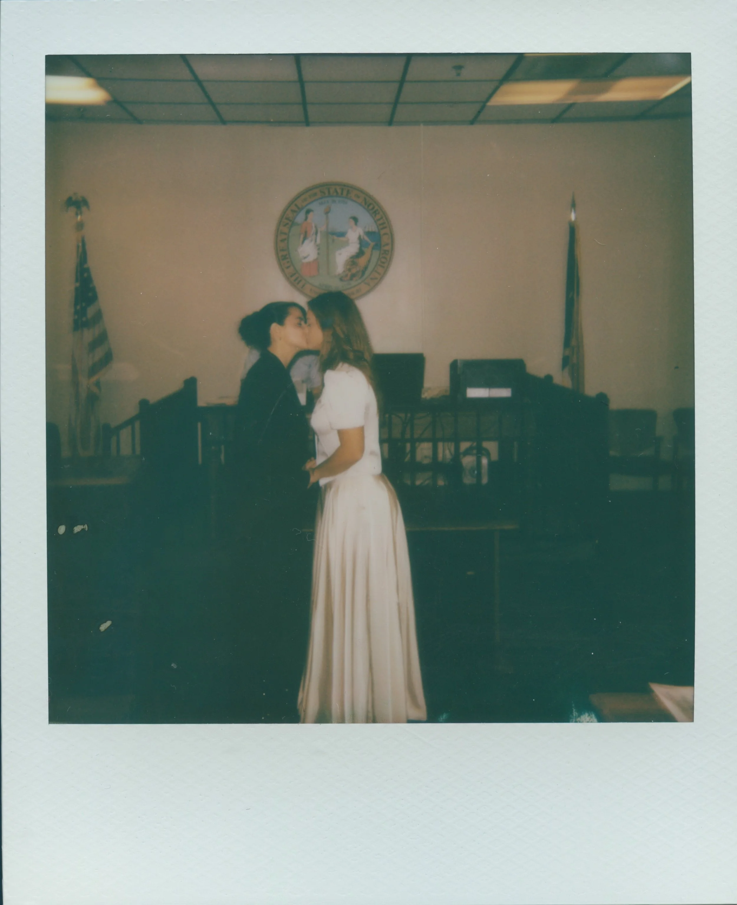 couple kissing at their courthouse elopement on polaroid film