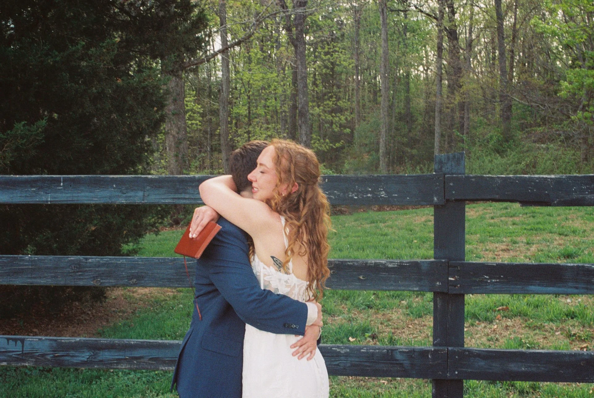 two brides embracing each other during private vow reading