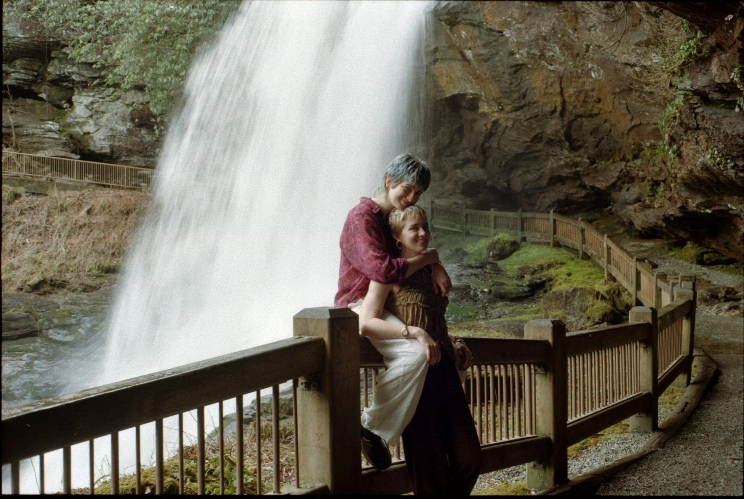 couple posing by dry falls waterfall in north carolina on film