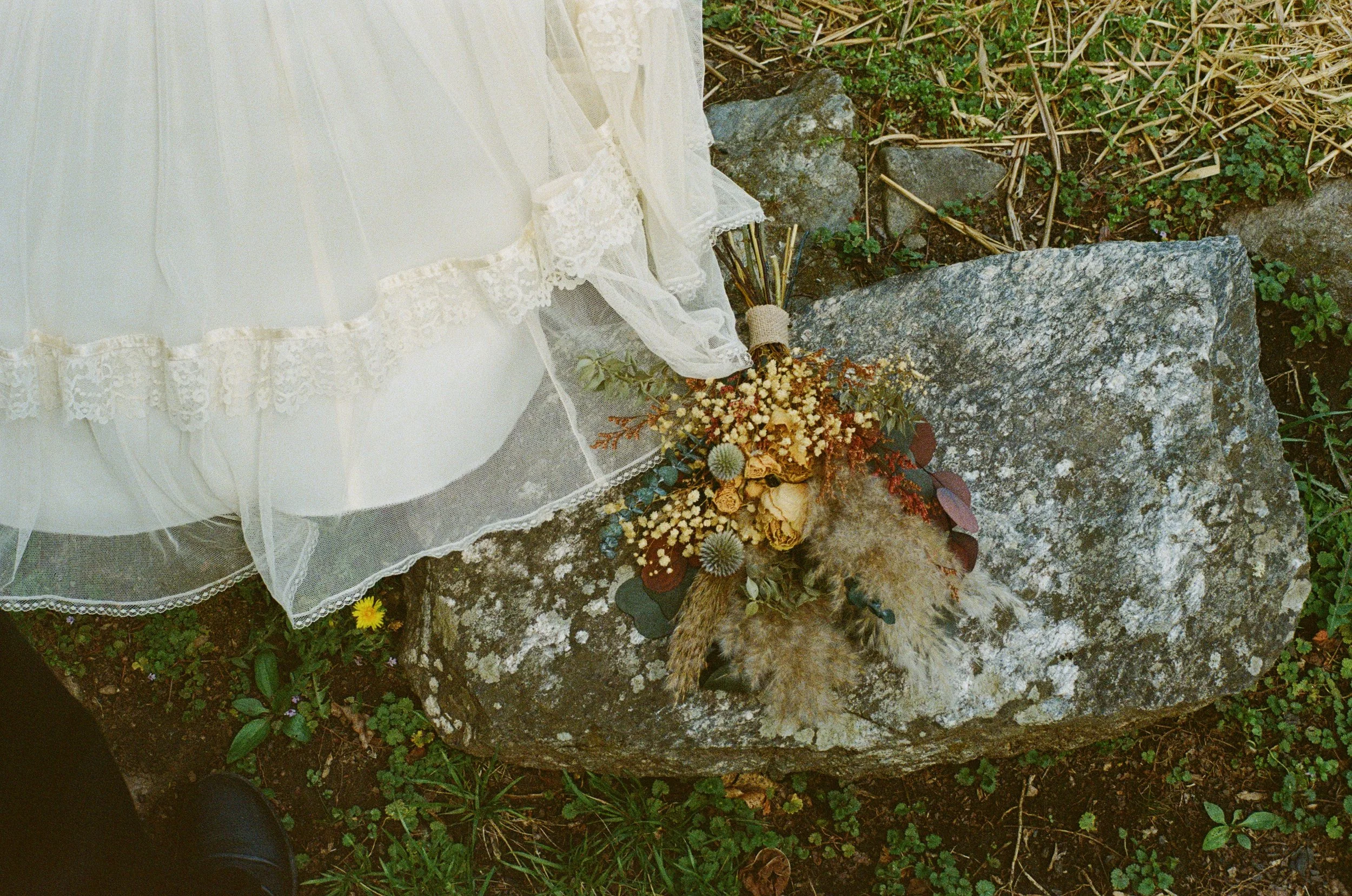 flower wedding bouquet sitting on a rock in the mountains of north carolina