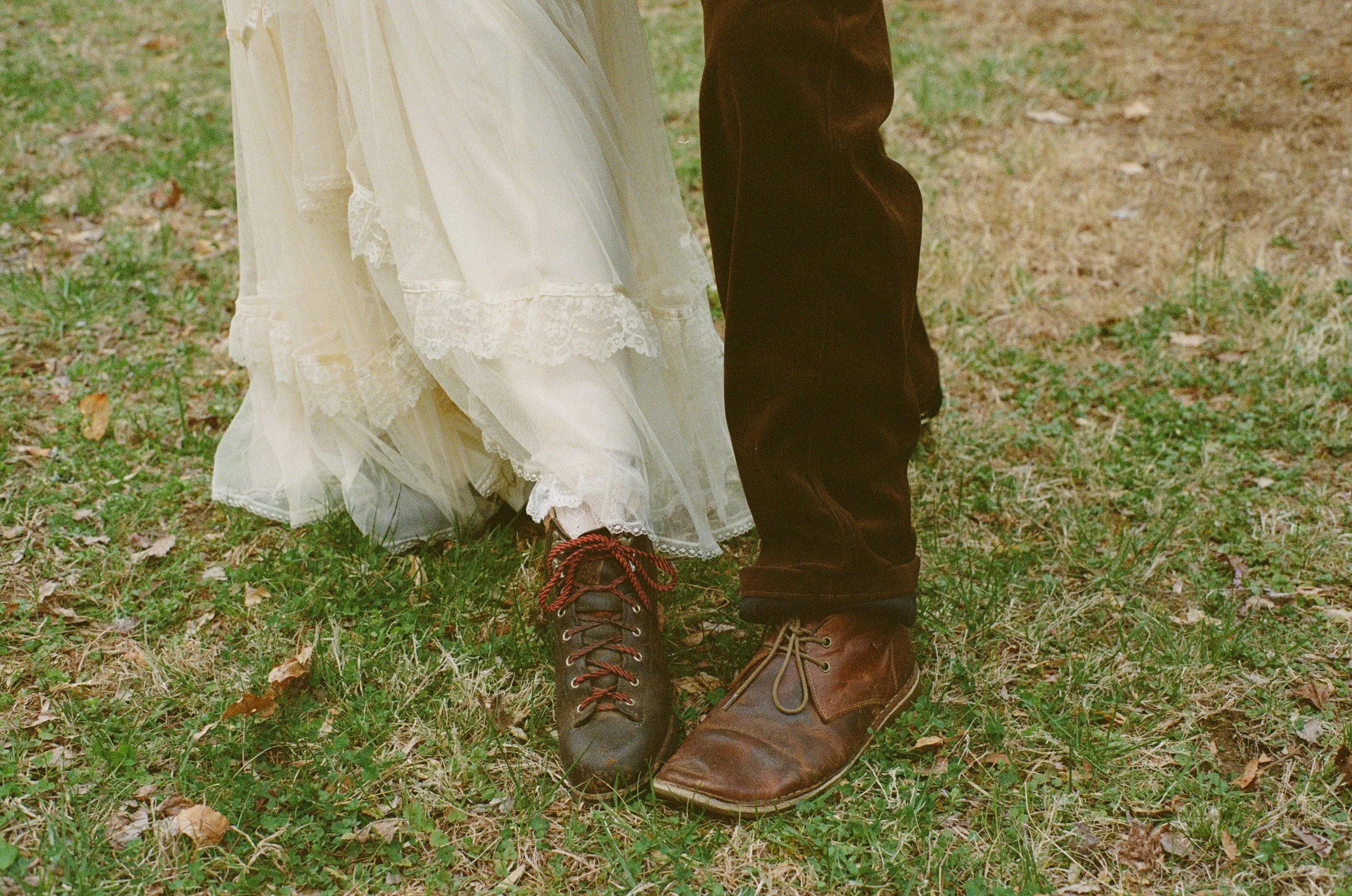 couple showing off hiking boots with their wedding attire