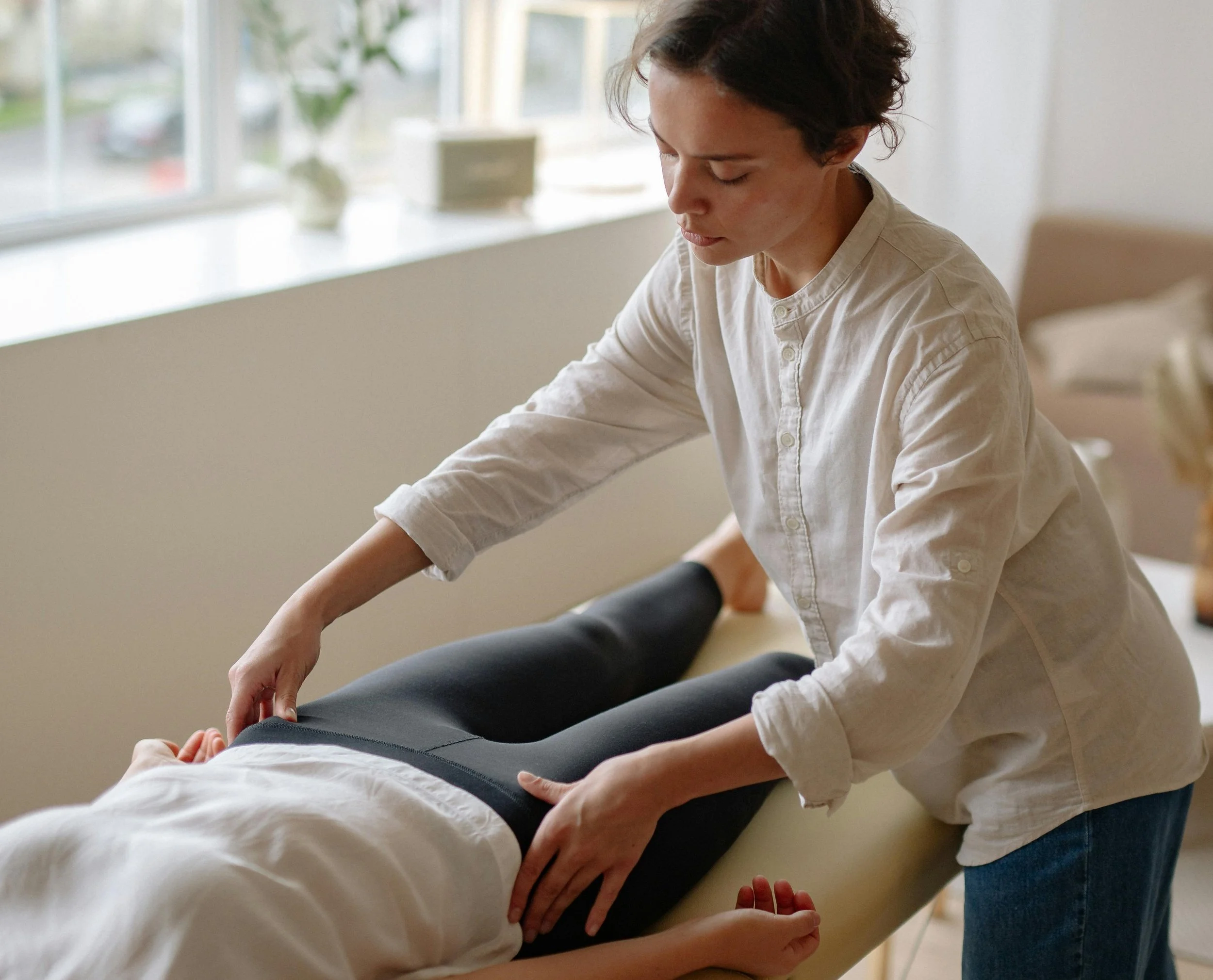 Ortho-Bionomy Practitioner with client.jpg